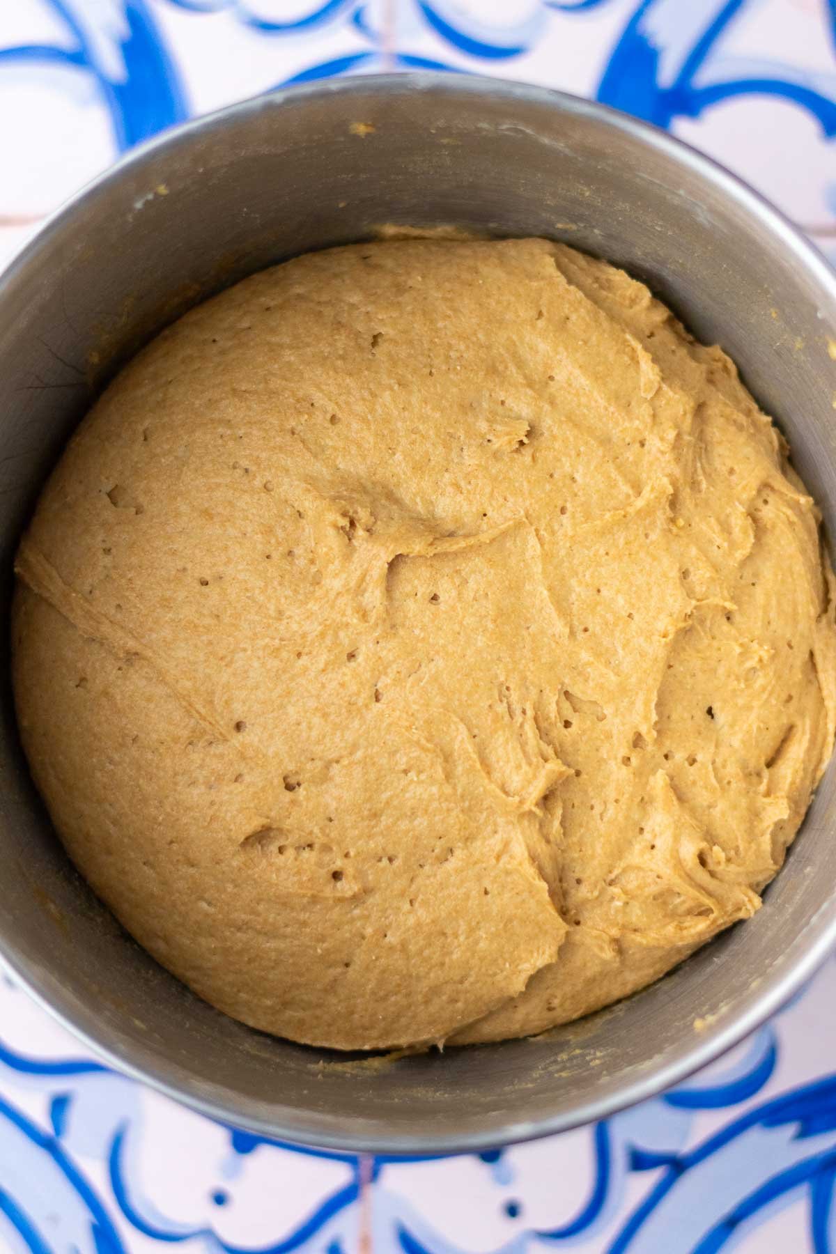 Doubled einkorn sourdough sandwich bread in bowl at the end of bulk fermentation.