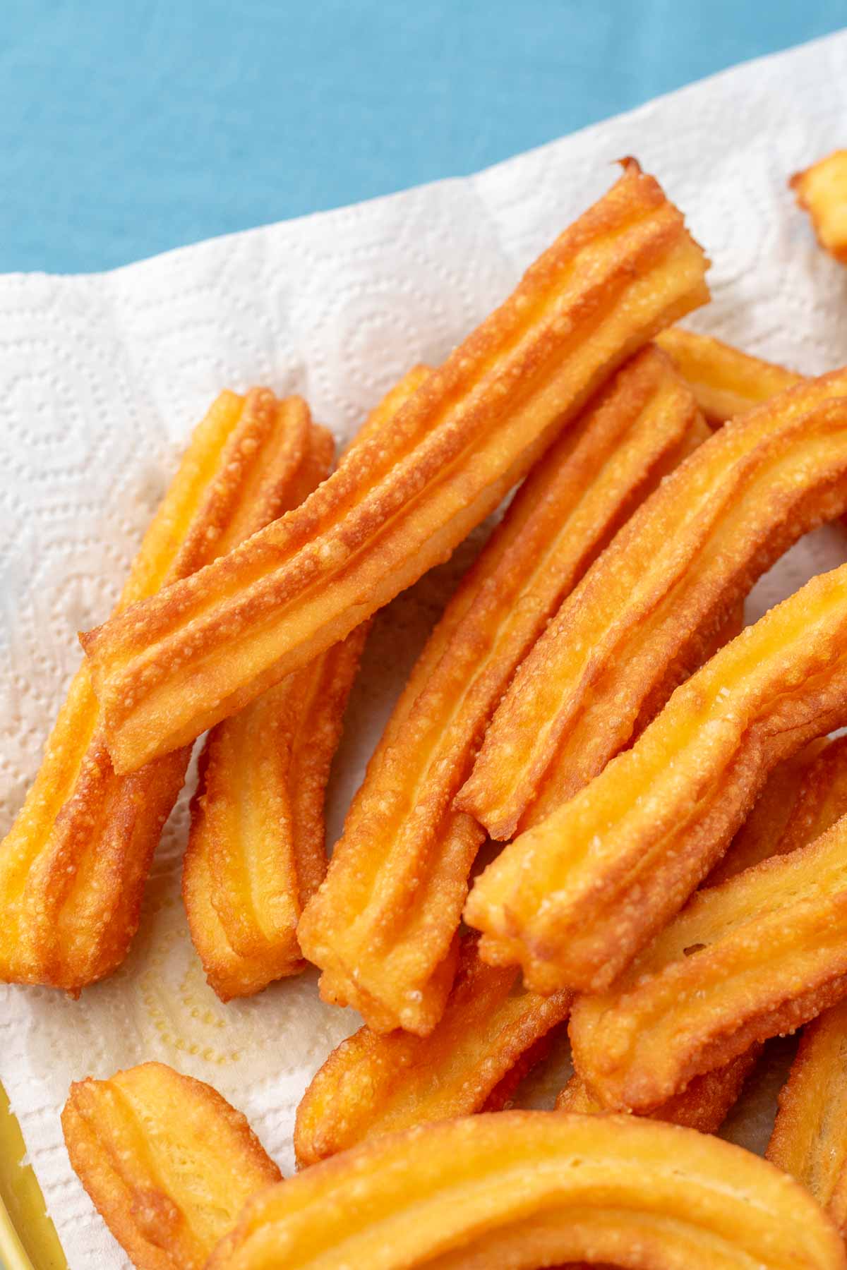 Fried sourdough churros resting on paper towels.