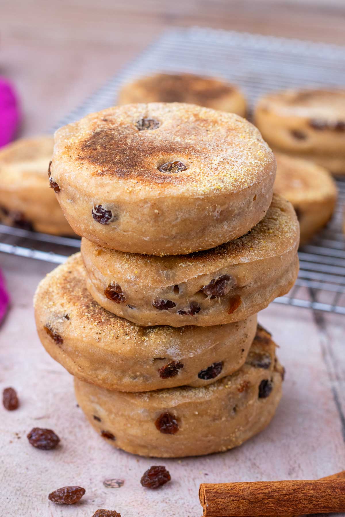 Stack of four sourdough cinnamon raisin english muffins.