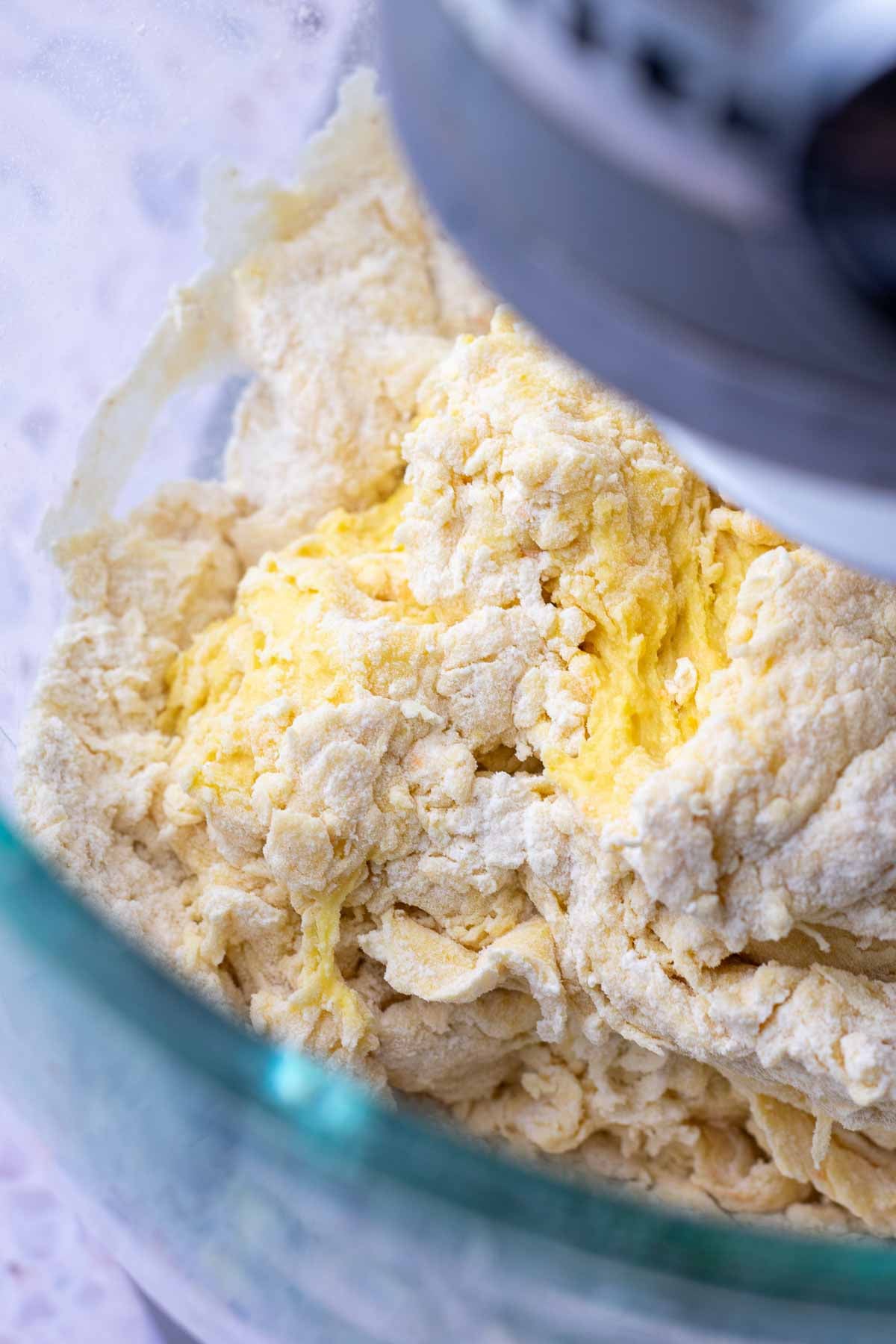 Mixing shaggy sourdough hot cross bun dough in a stand mixer.