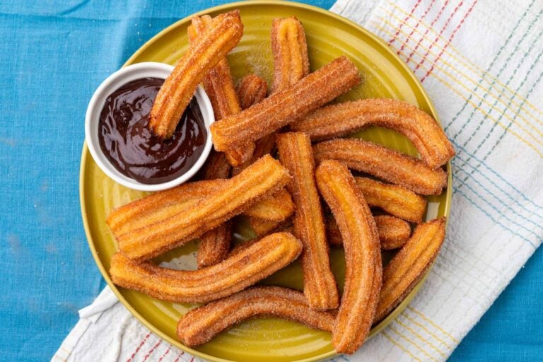 Sourdough Churros on a plate with chocolate dipping sauce