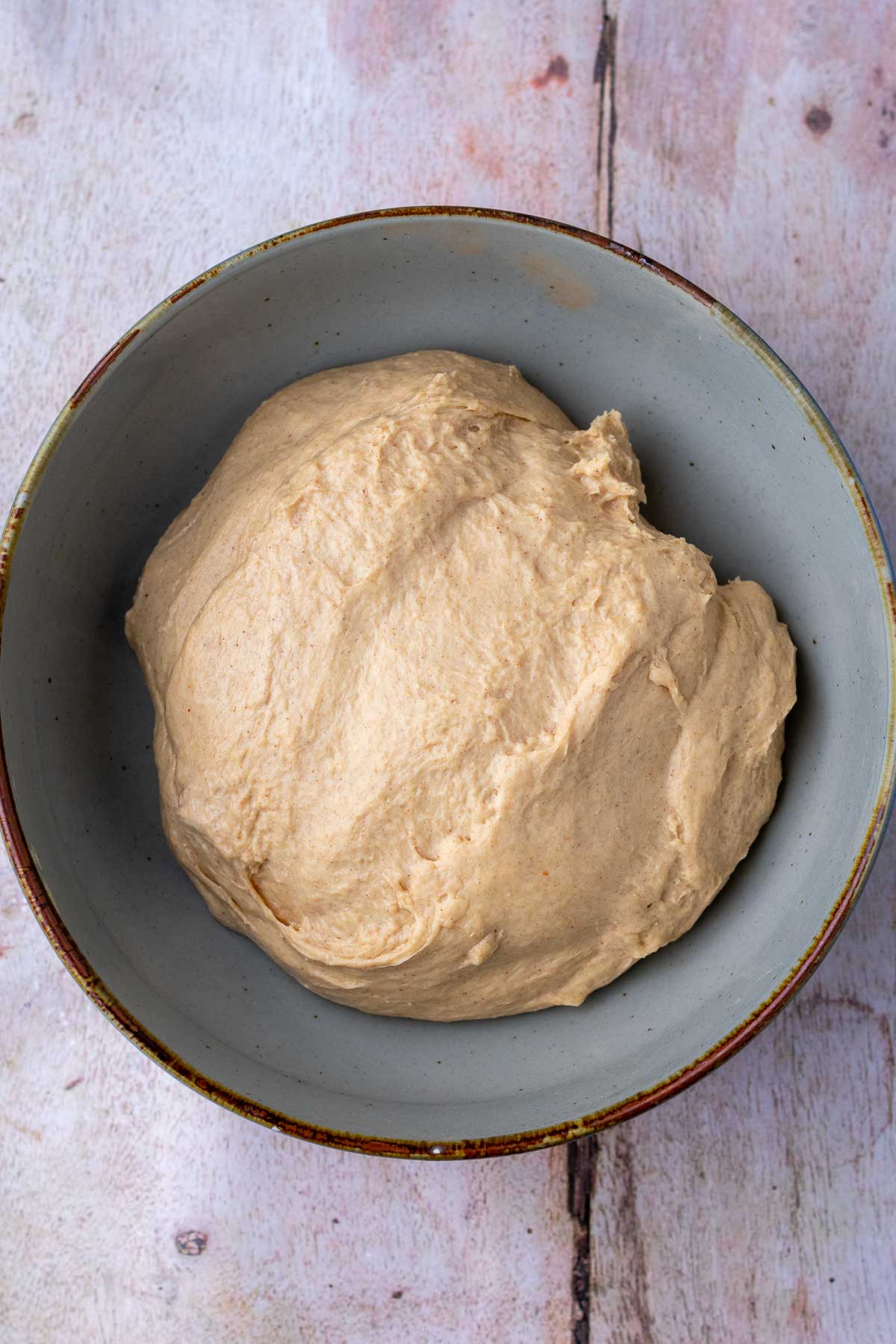 Sourdough cinnamon raisin english muffin dough in bowl at the start of bulk fermentation.