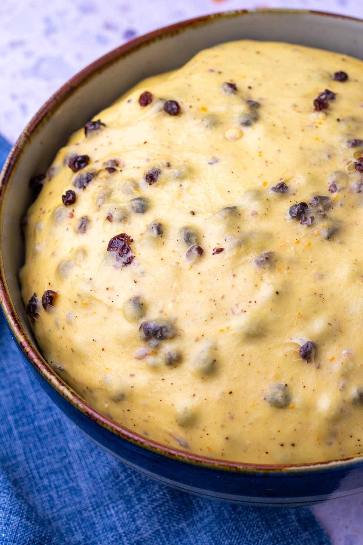 Sourdough hot cross bun dough in a bowl at the end of bulk fermentation.