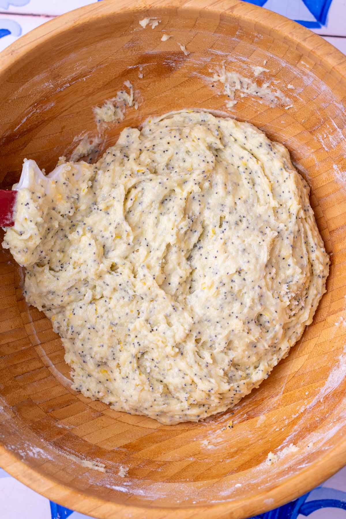Mixed sourdough lemon poppy seed muffin batter in a large wooden bowl.