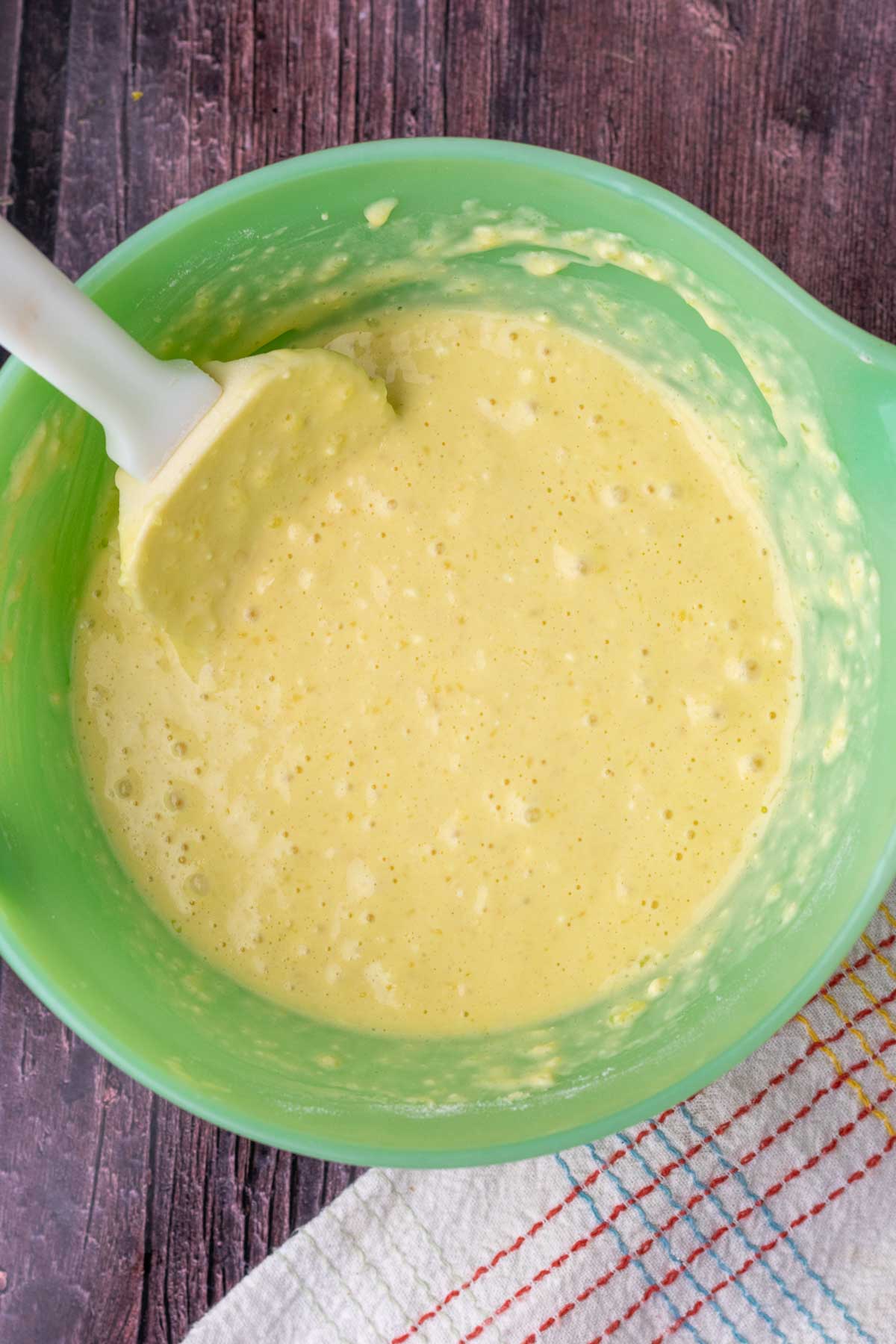 Mixed sourdough buttermilk pancake batter in a bowl with a spatula.