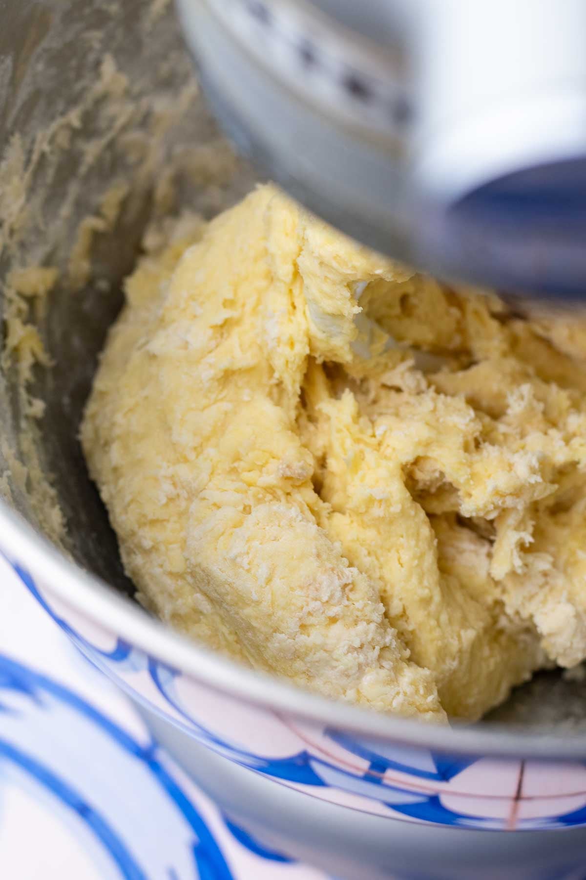 Start of mixing sourdough hot dog bun dough in a stand mixer bowl.