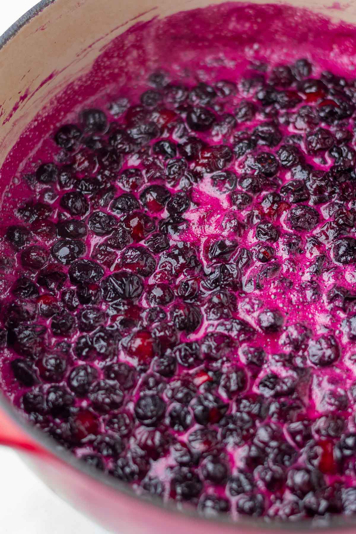Start of cooking blueberry jam in a large pot.