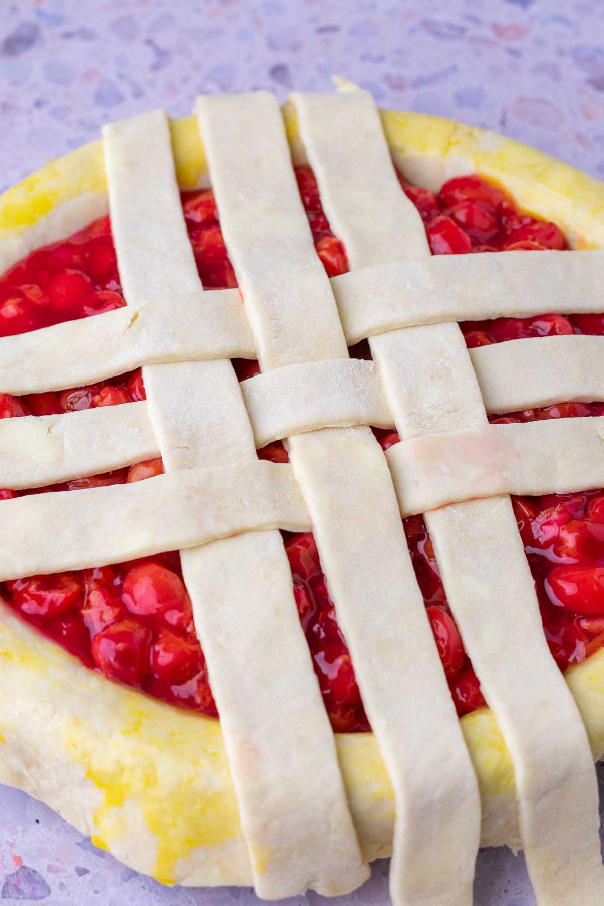 Weaving lattice on sour cherry pie.