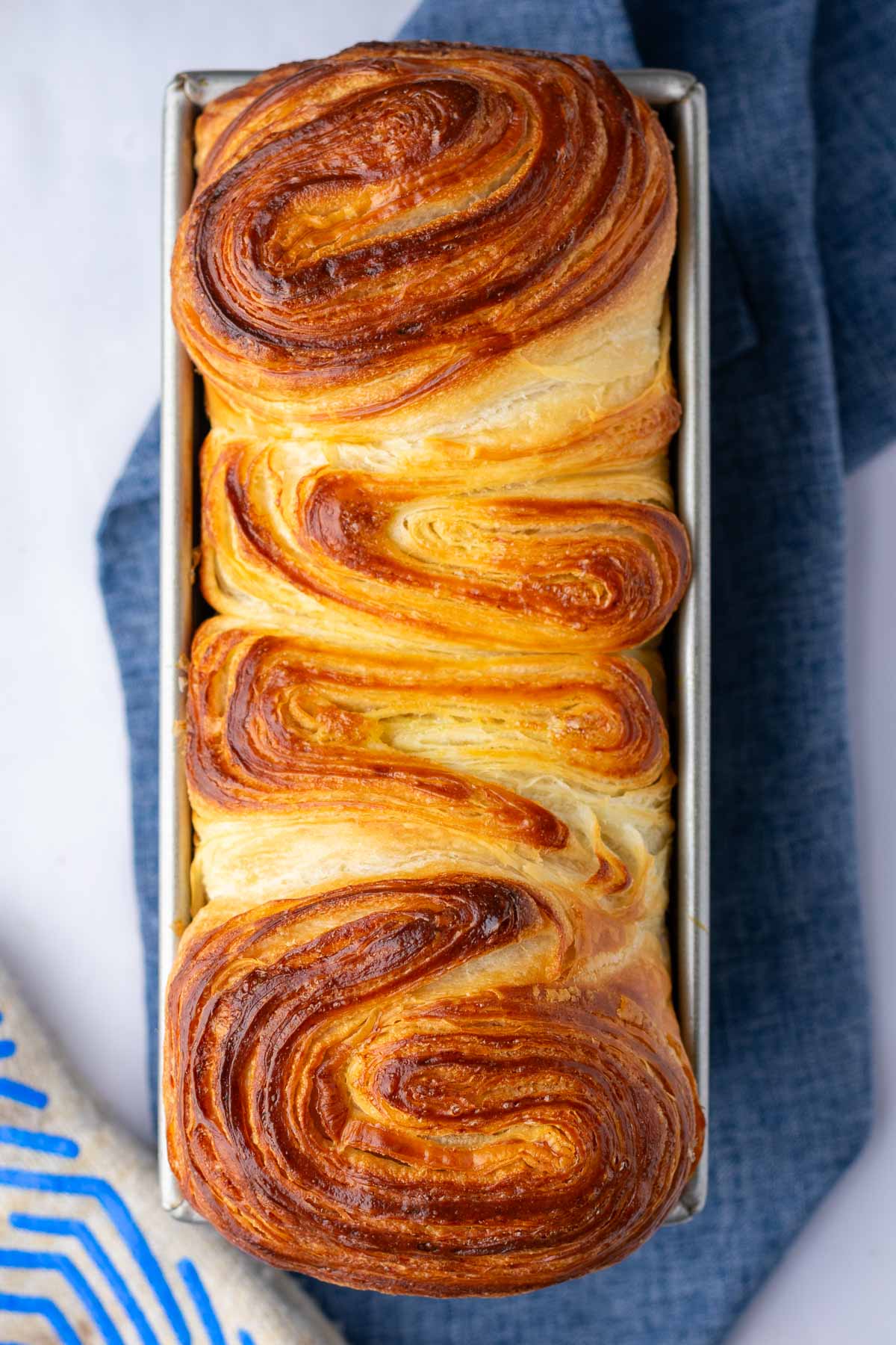 Baked sourdough croissant bread loaf in a loaf pan