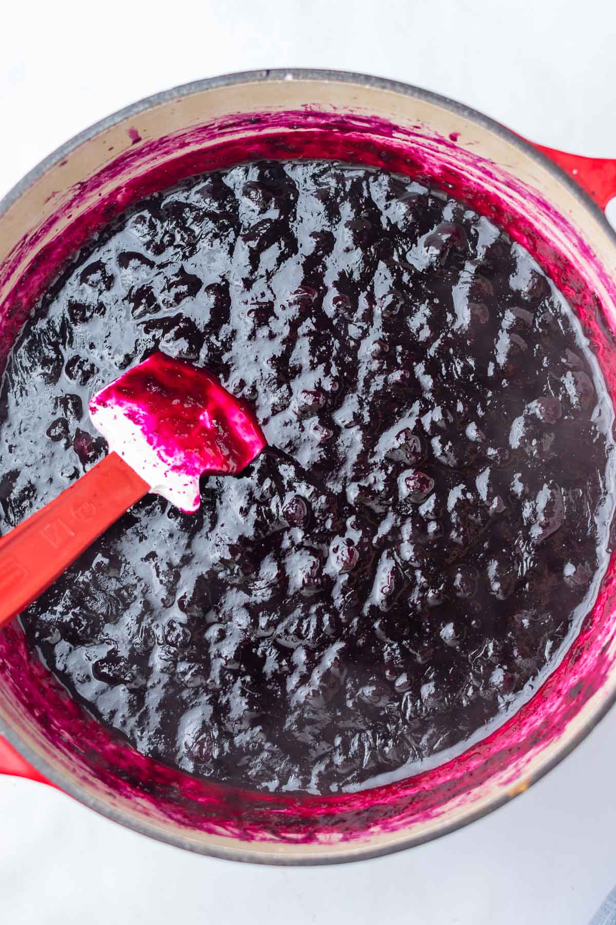 Cooked blueberry jam in a Dutch oven.