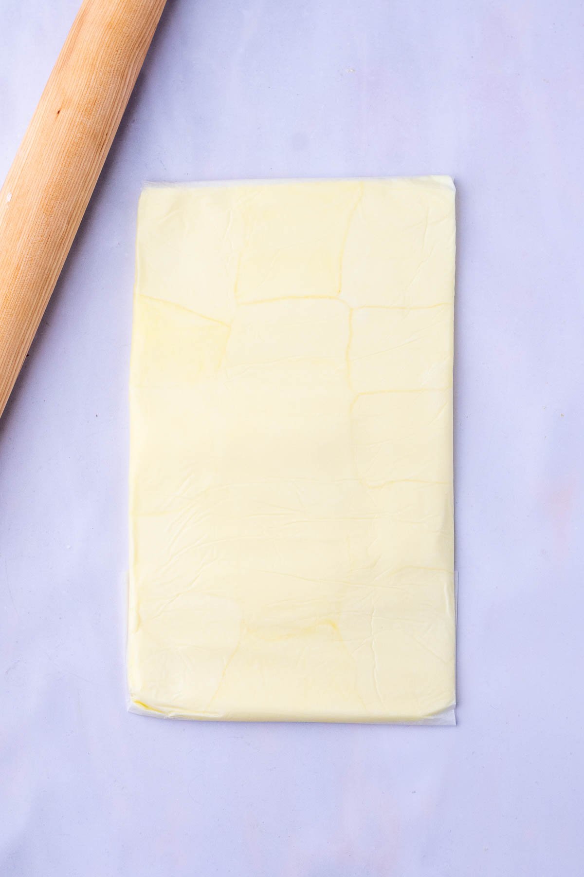 Butter block for sourdough croissant bread loaf with a rolling pin.