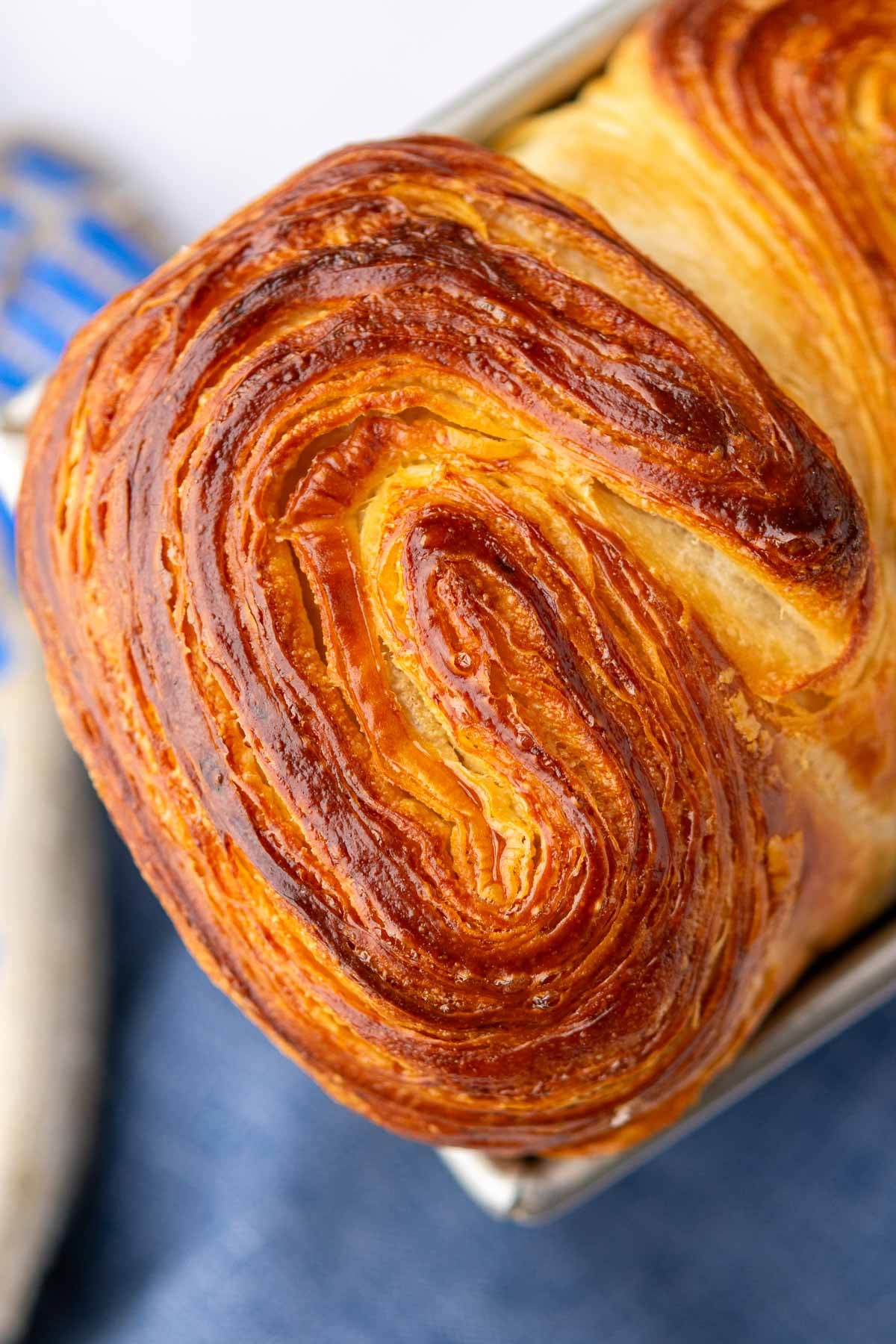 Detailed flaky layers of sourdough croissant bread loaf.