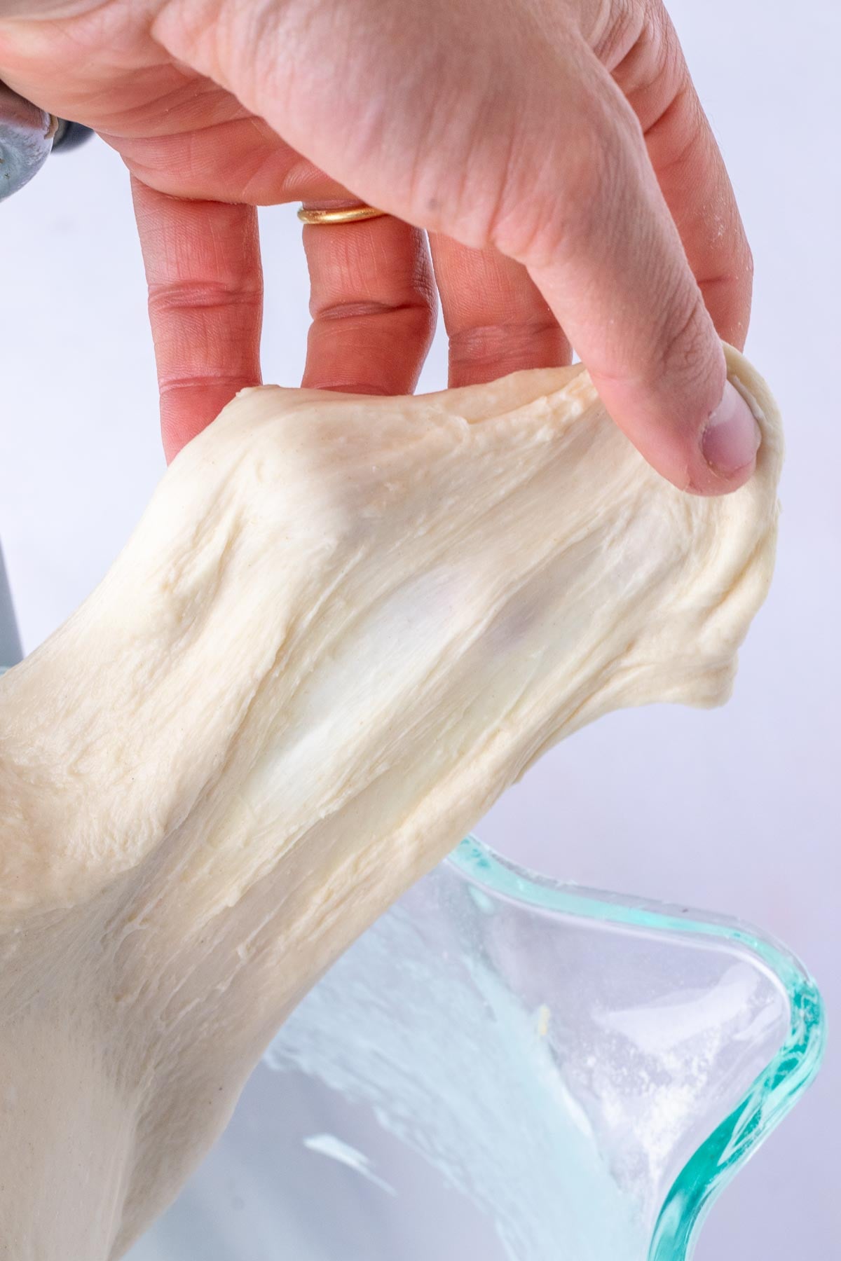 Mixed sourdough croissant bread loaf dough passing the windowpane test.