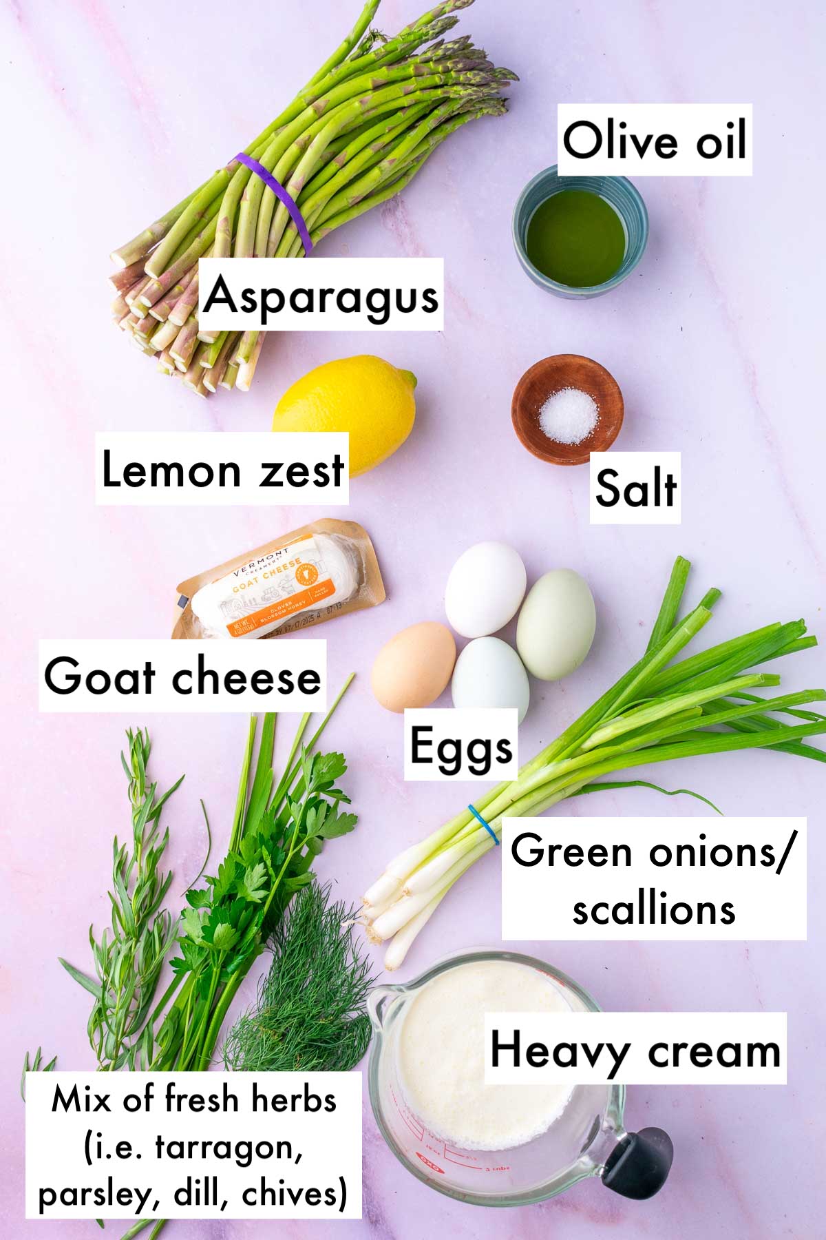 Labeled ingredients needed for asparagus goat cheese sourdough quiche including asparagus, olive oil, salt, lemon zest, goat cheese, eggs, scallions, fresh herbs, and heavy cream.