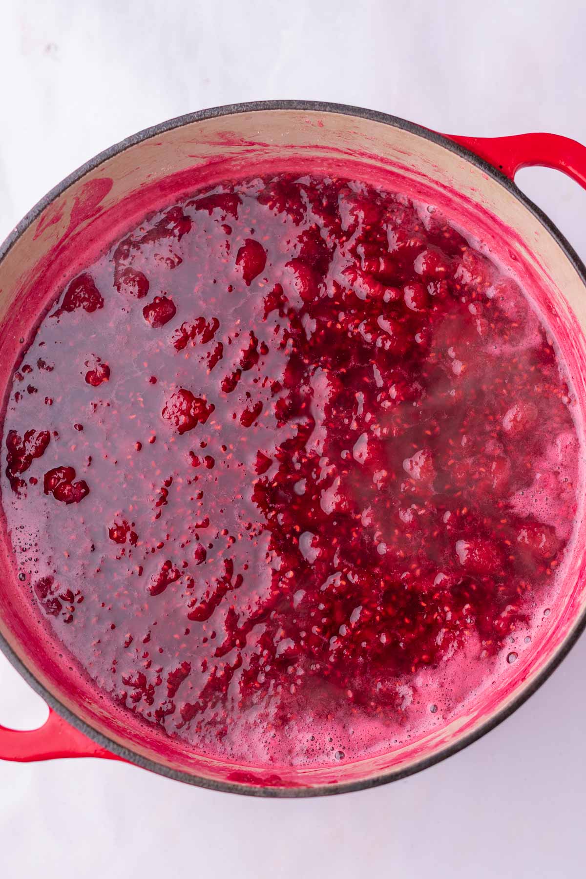 Cooking Raspberry Rose Jam in a Dutch oven.