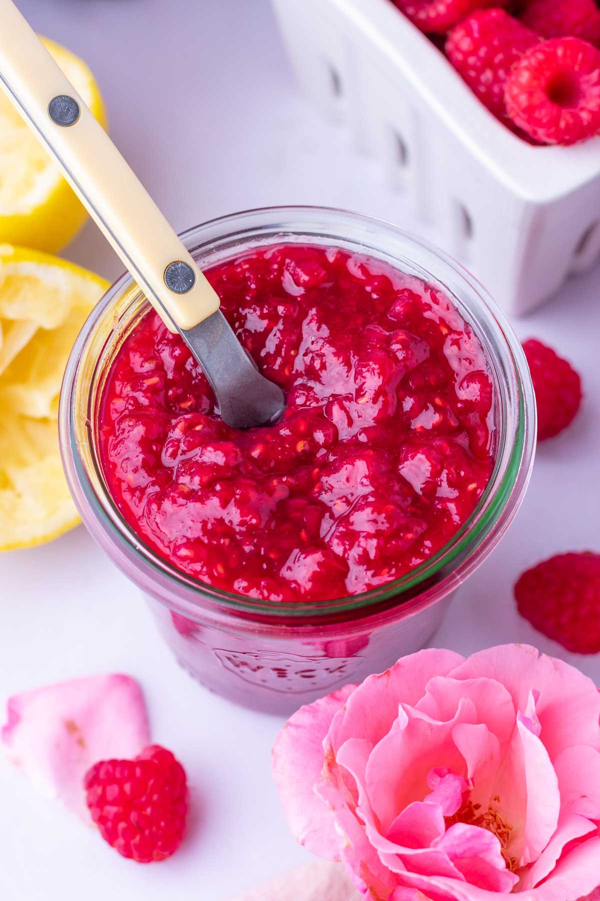 Spoon in a jar of Raspberry Rose Jam.