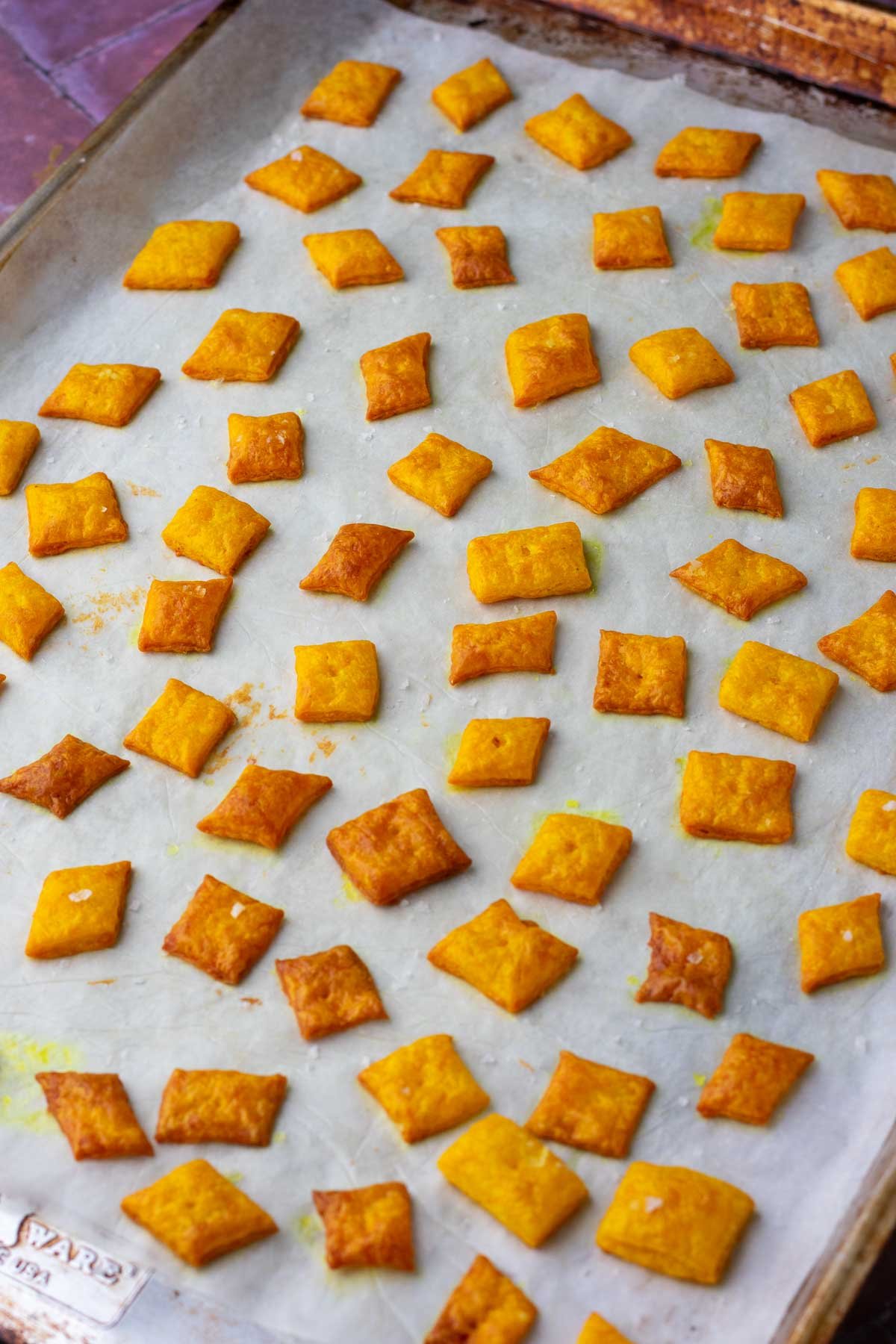 Baked Sourdough discard cheese crackers on a baking sheet.