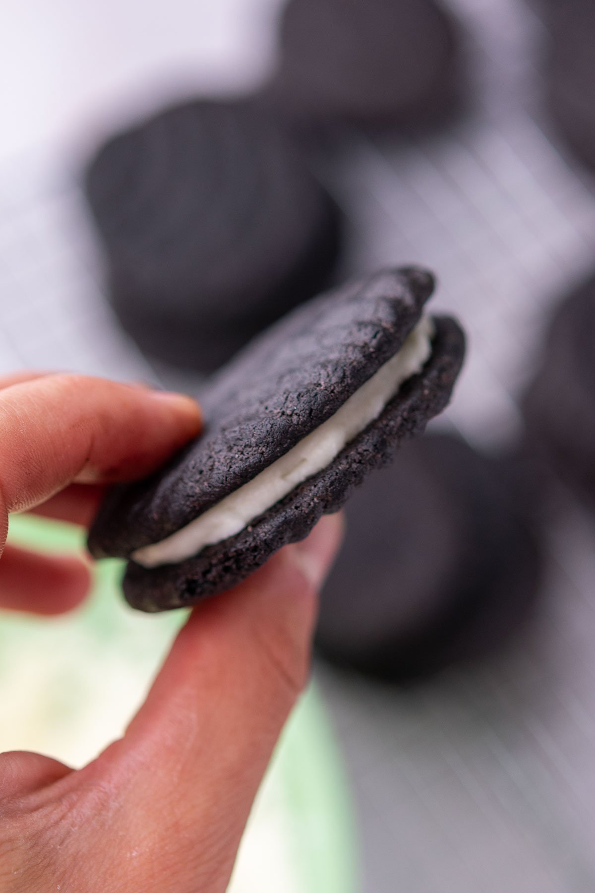 Hand holding a sandwiched sourdough oreo.