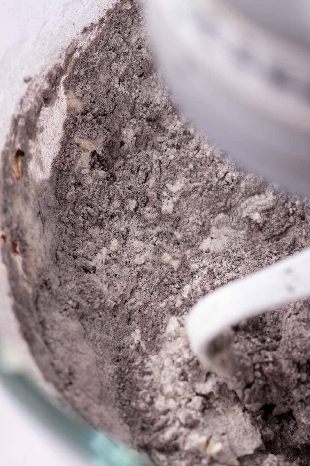 Mixing dry ingredients into wet ingredients for sourdough oreos.