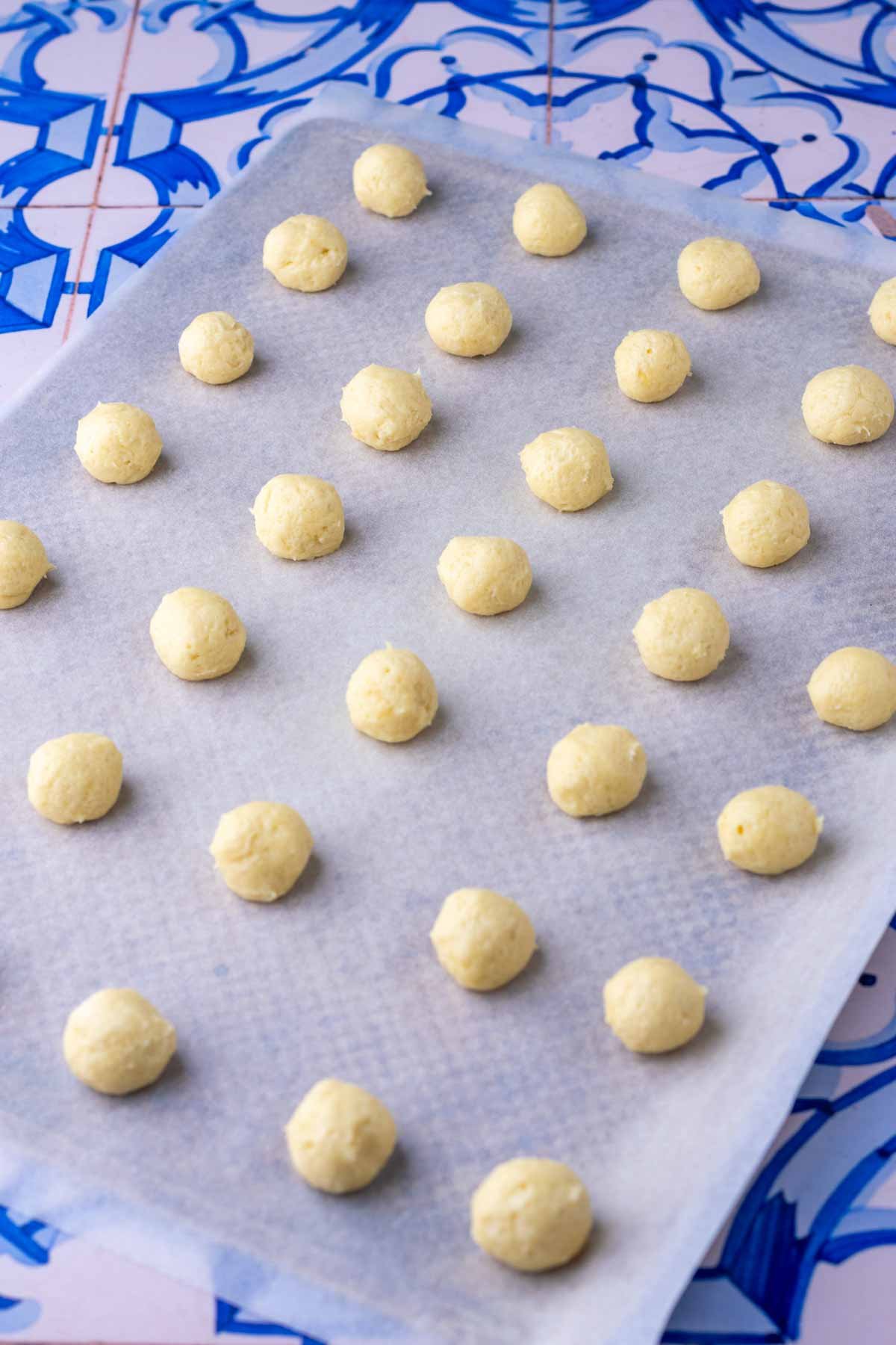Shaped sourdough vanilla wafers on sheet pan.