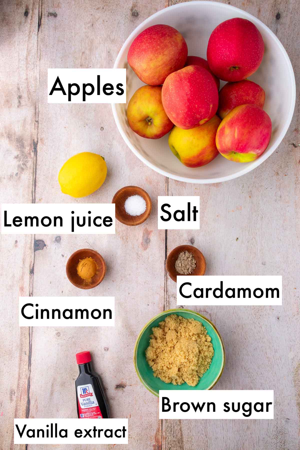 Labeled ingredients needed for apple crisp filling including apples, salt, lemon juice, cinnamon, cardamom, brown sugar, and vanilla extract.