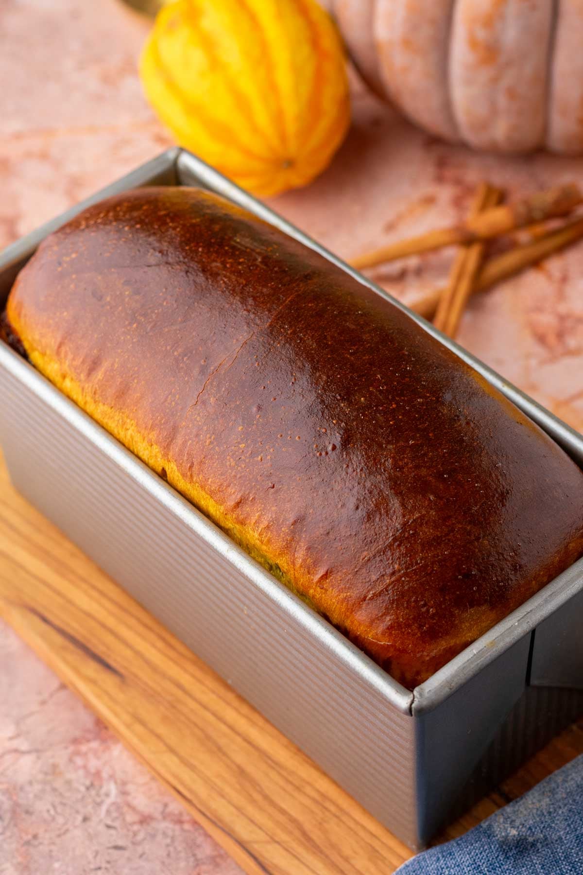 Baked sourdough pumpkin cinnamon swirl bread in bread loaf pan.