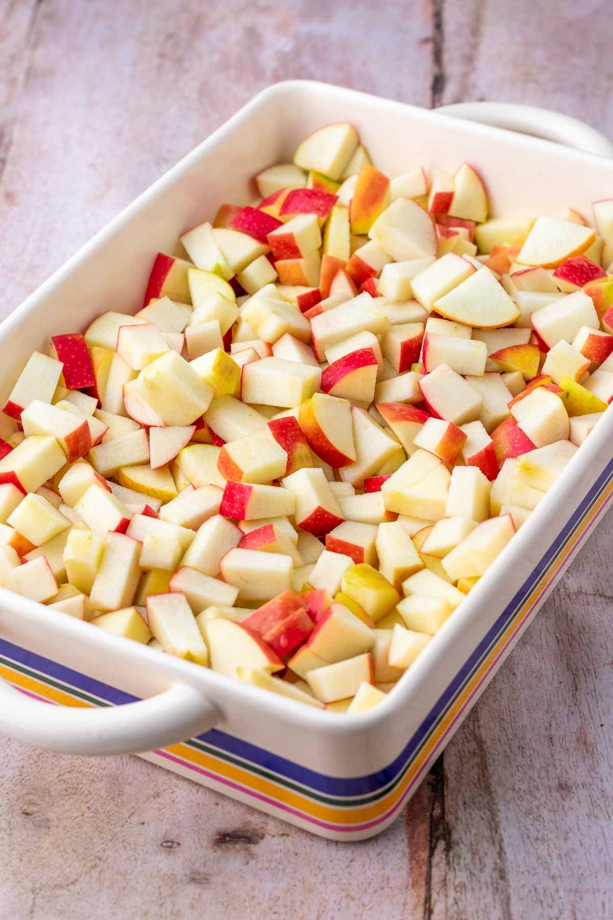 Chopped apples in baking dish for apple crisp.
