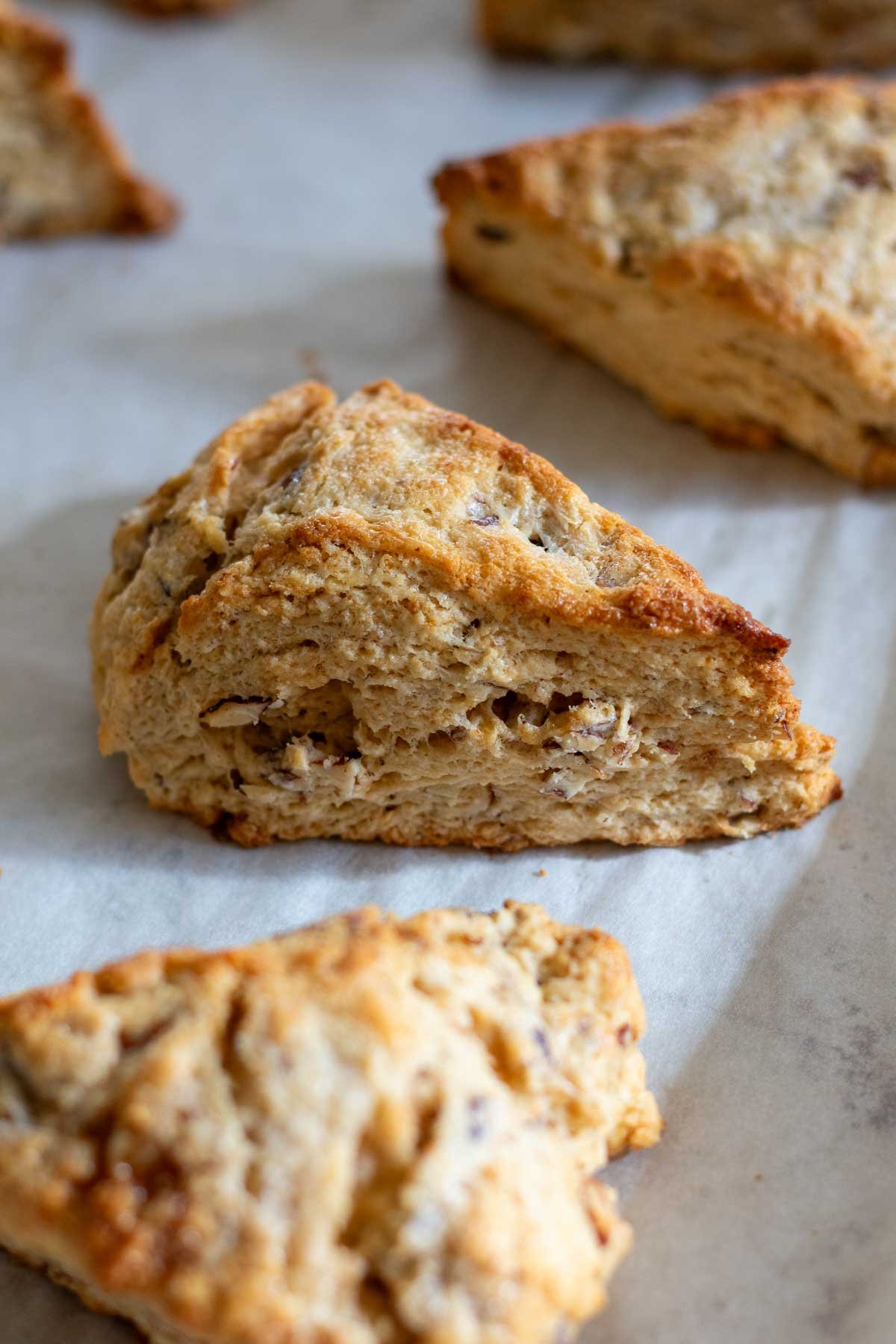 Baked sourdough maple pecan scone on a sheet pan without glaze.