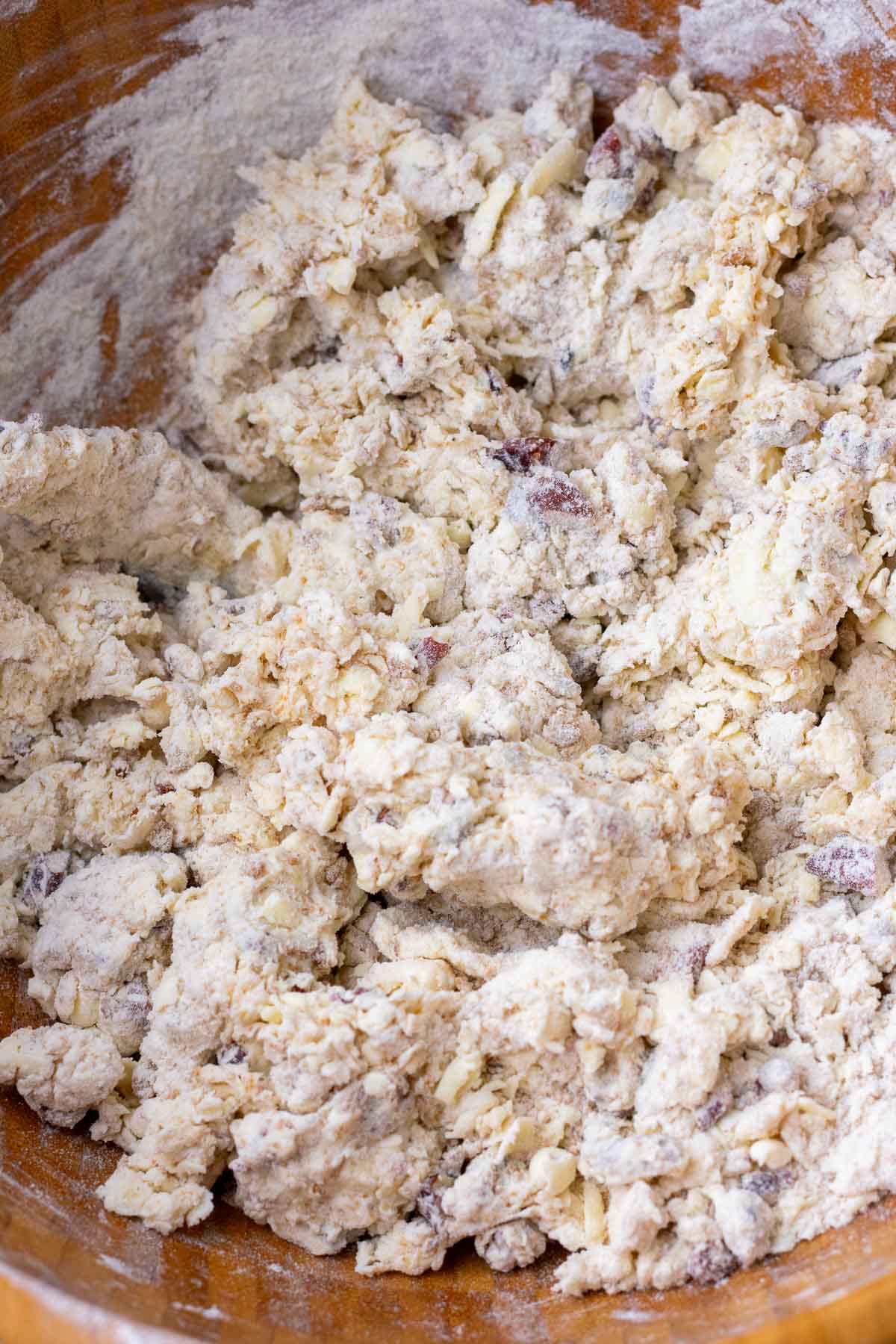 Mixing sourdough maple pecan scone dough in a bowl.