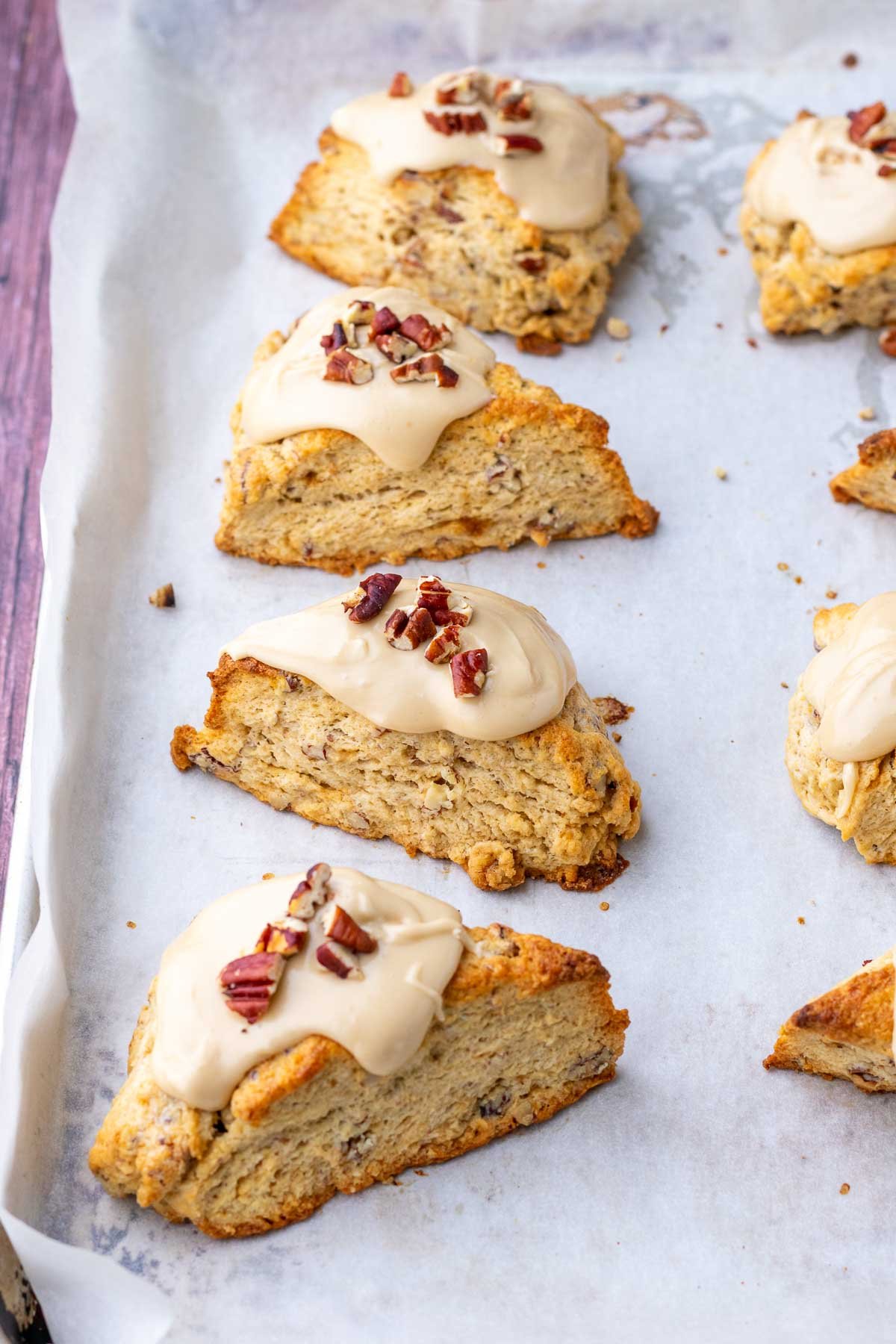 Baked sourdough maple pecan scones on a sheet pan.