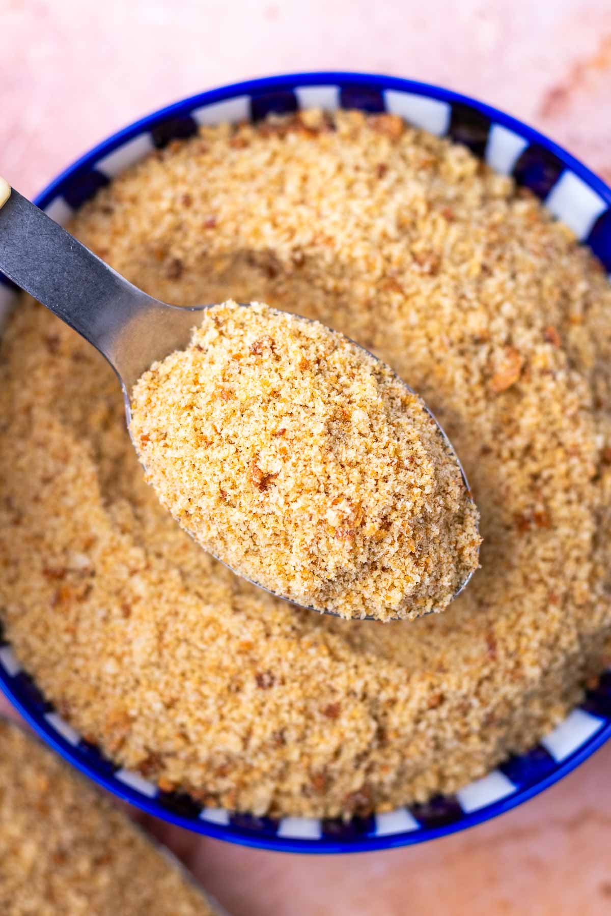 Bowl of sourdough breadcrumbs with a spoon.
