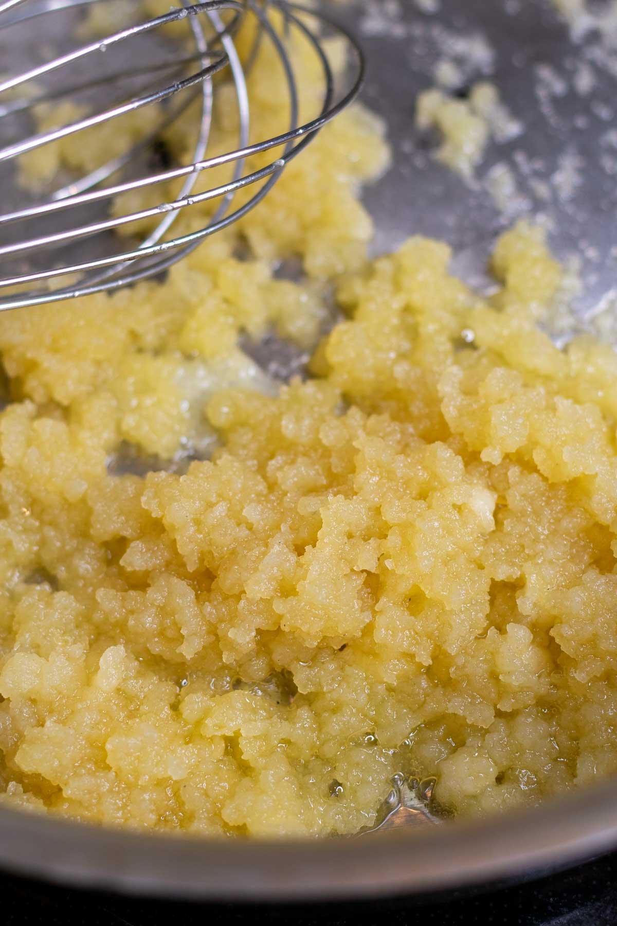Cooked sourdough discard roux with a whisk.