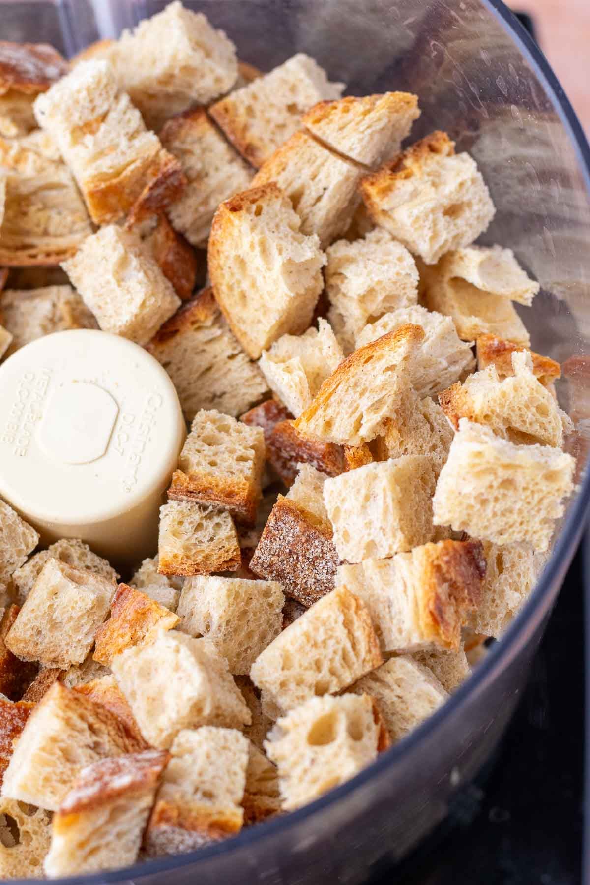 Cubes of sourdough bread in a food processor.