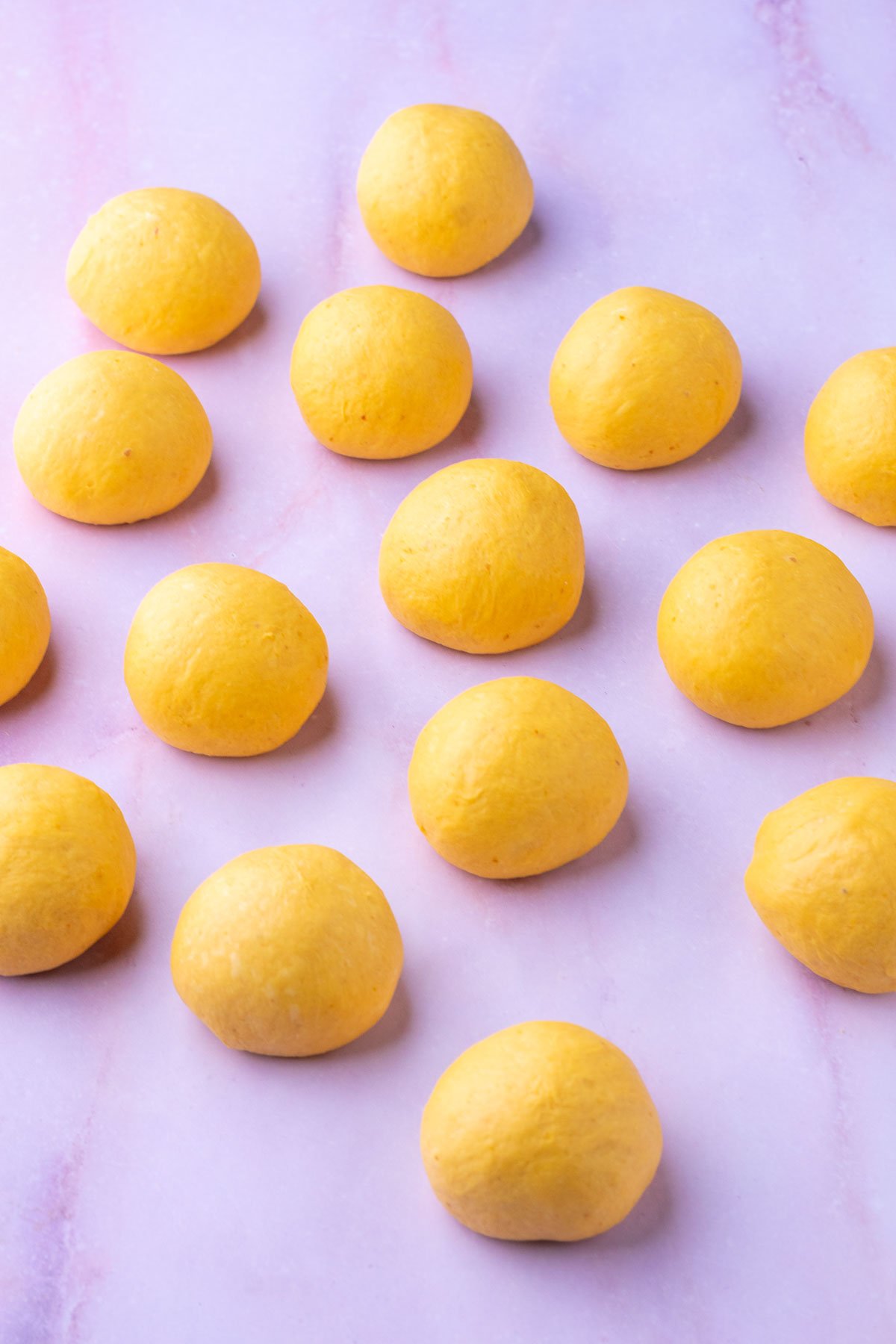 Shaped sourdough pumpkin dinner roll balls.