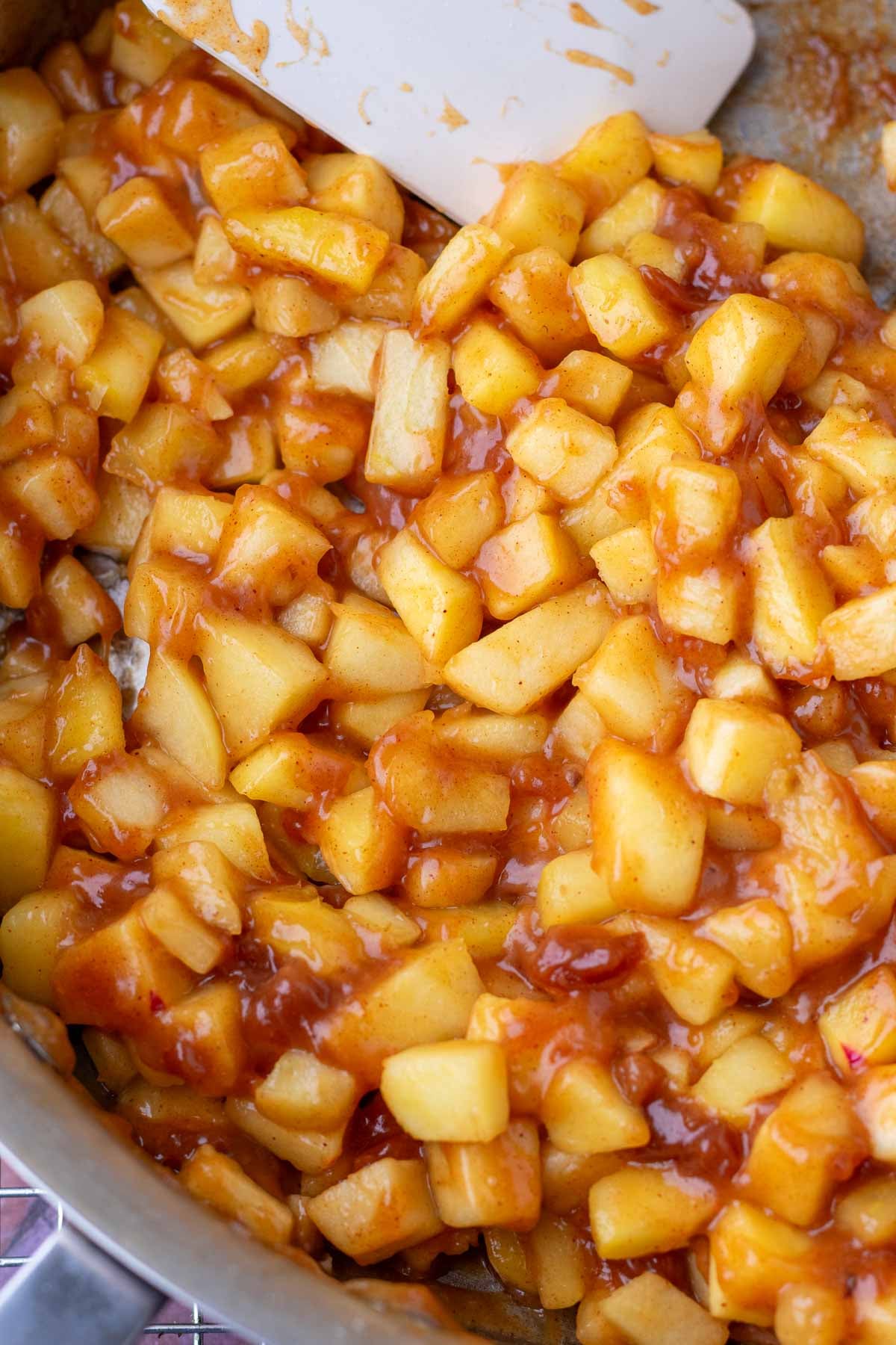 Cooked sourdough apple hand pie filling in a pan with a spatula.