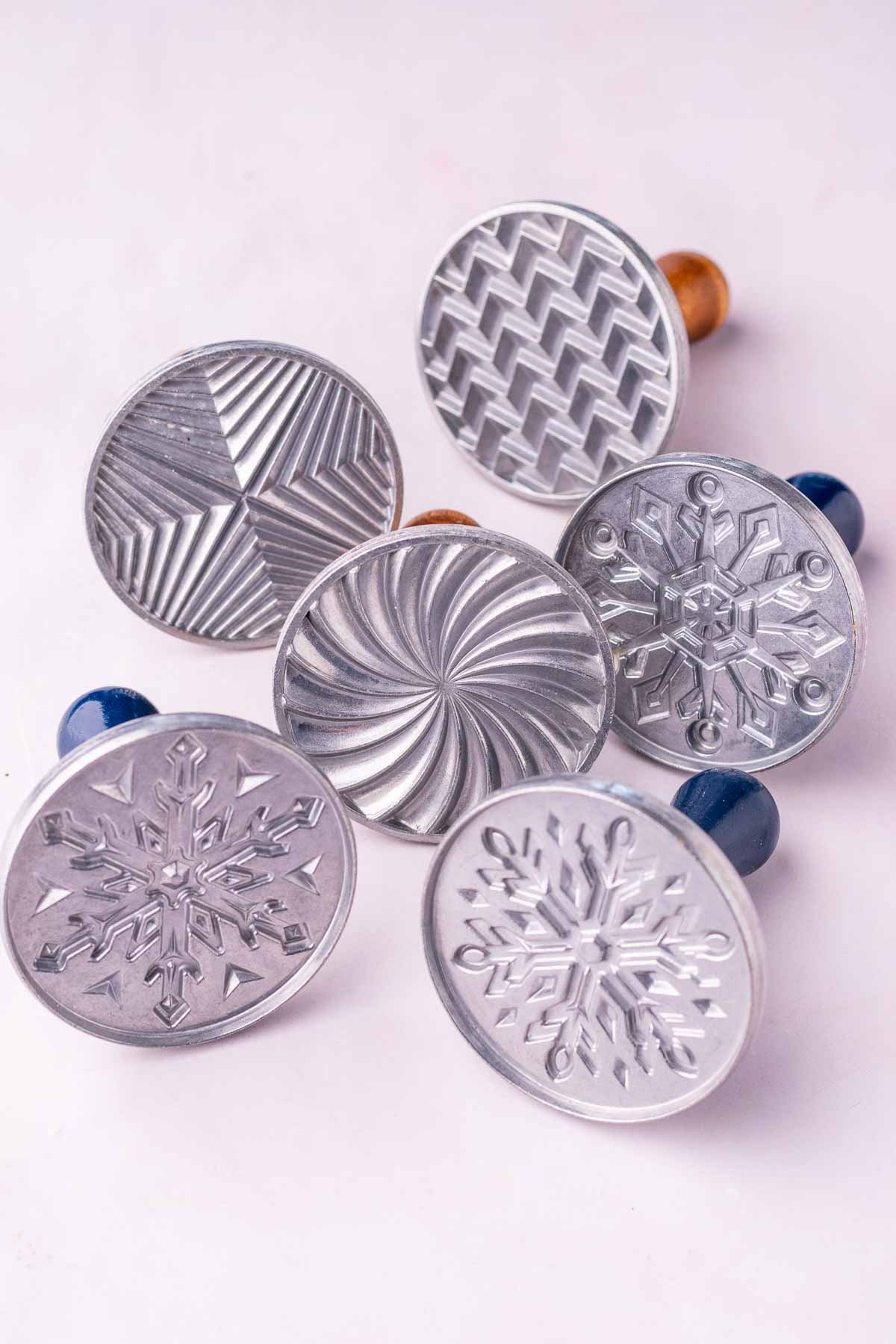Cookie stamps with snowflake and geometric patterns.