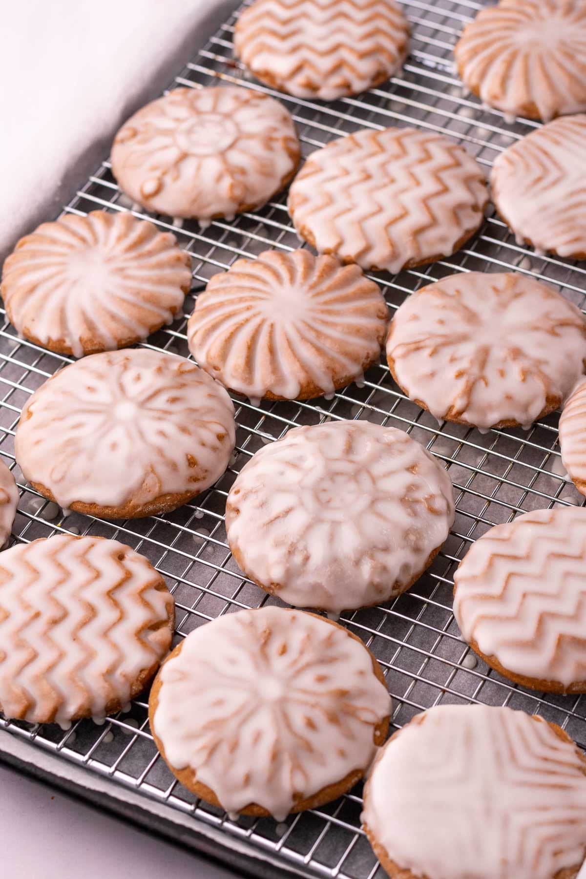 Soft glazed sourdough gingerbread cookies on a wire rack.