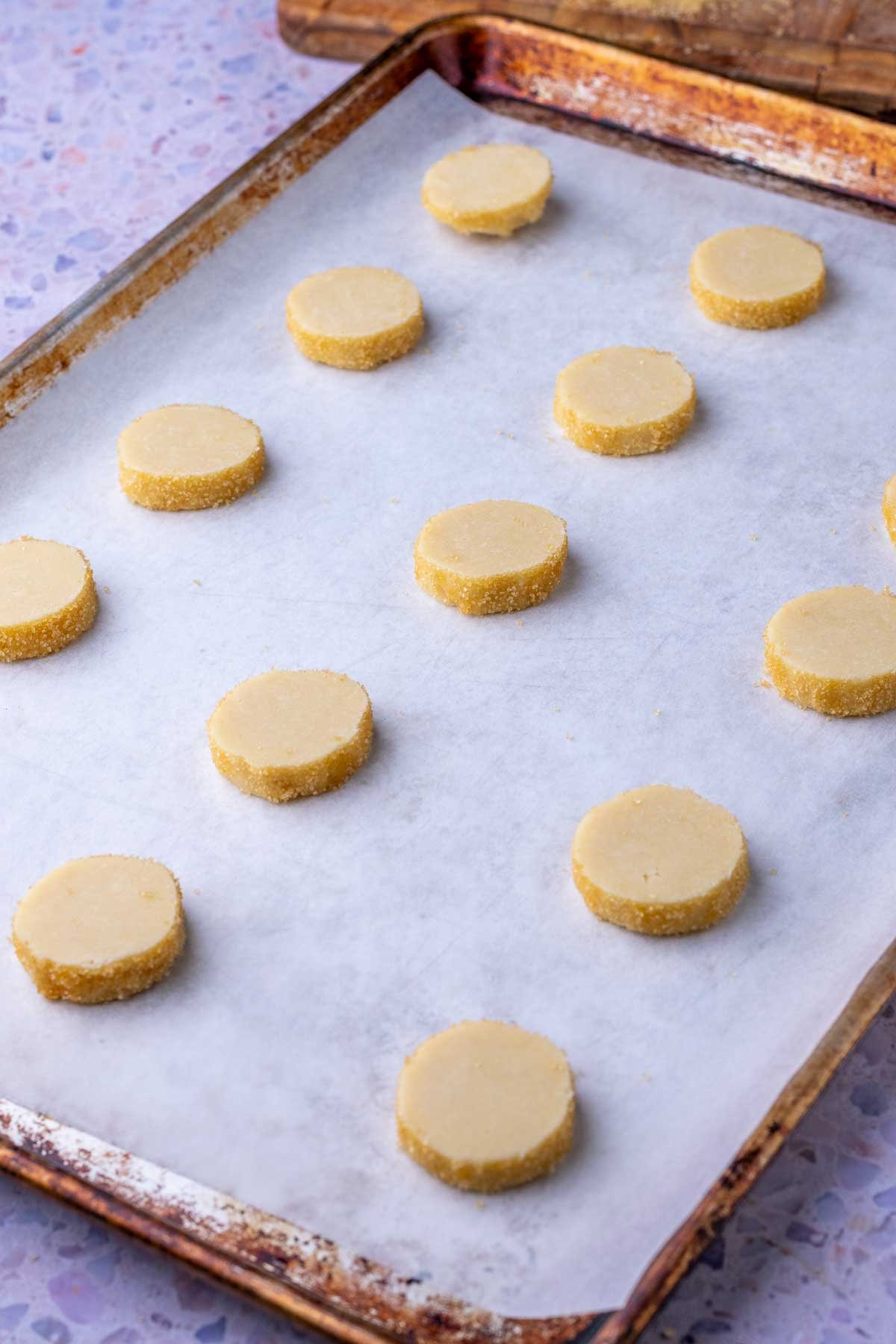 Unbaked sourdough shortbread cookies on a baking sheet.