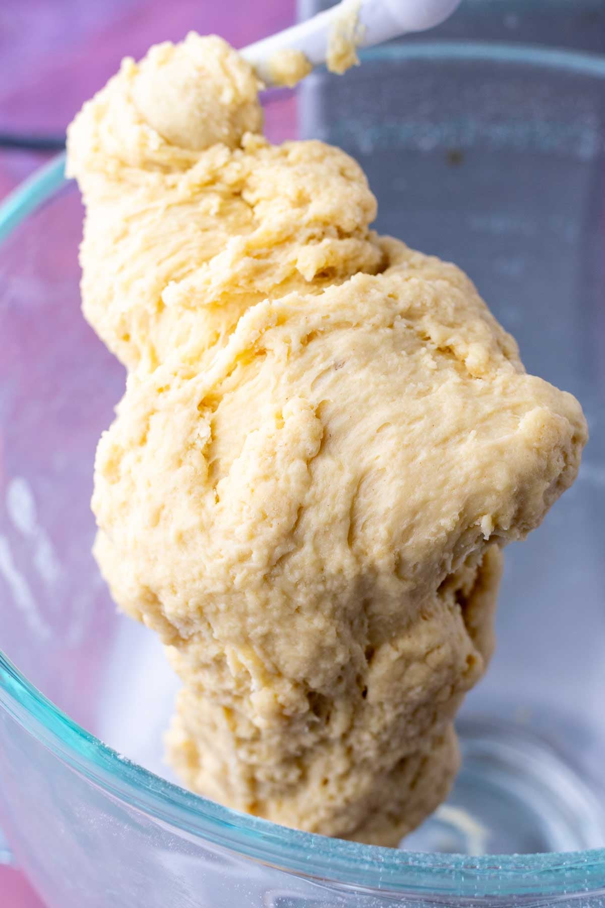 Start of mixing sourdough brioche dough on the bread hook of a stand mixer.