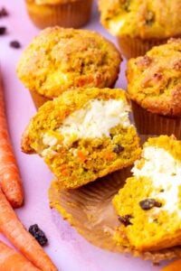 Sliced sourdough carrot cake muffin with cream cheese filling.