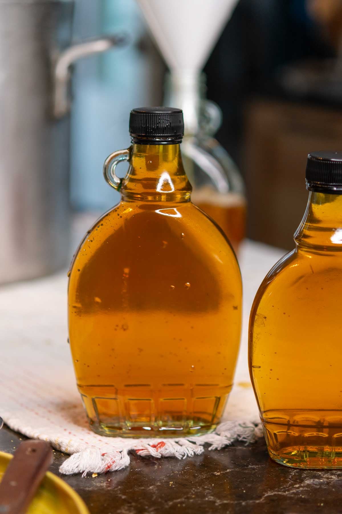 Jarred maple syrup on a towel.