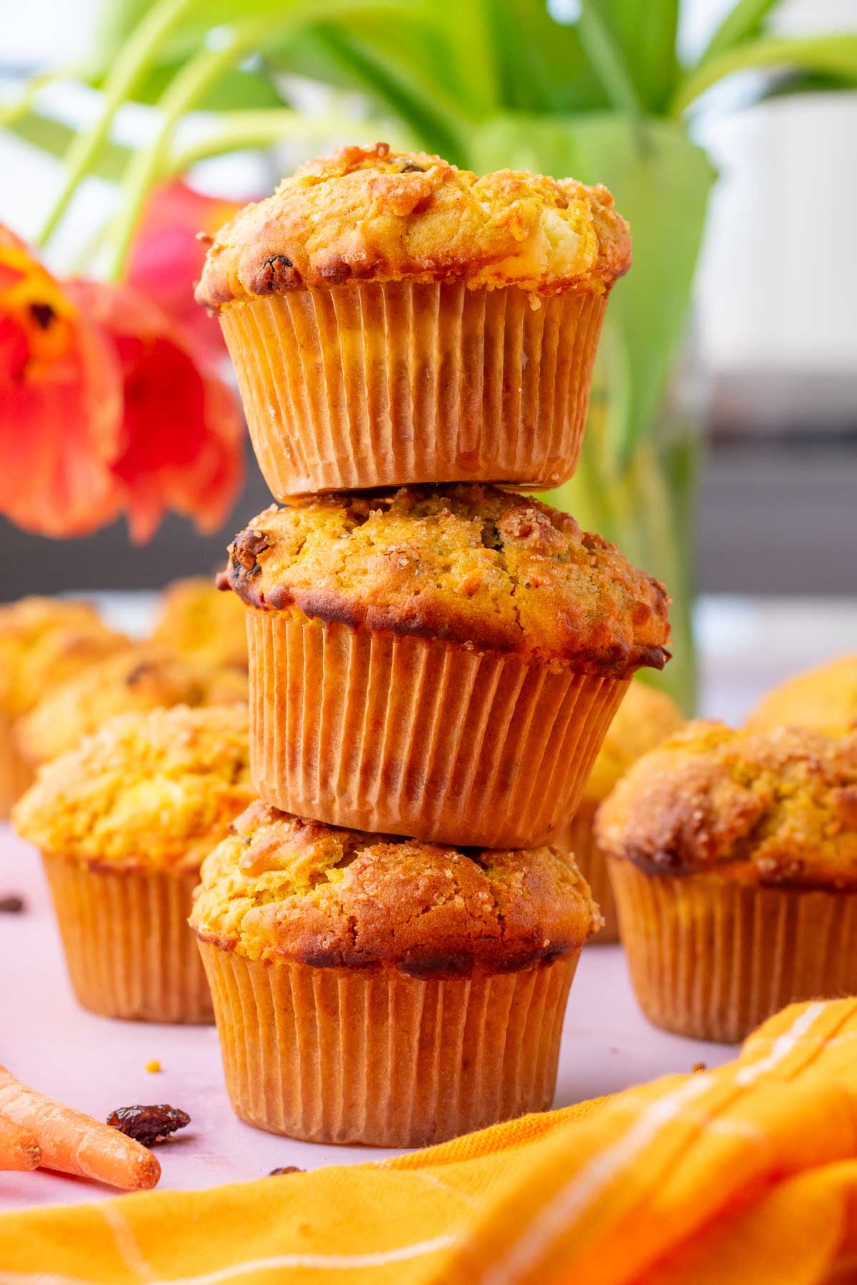 Stack of three sourdough carrot cake muffins.
