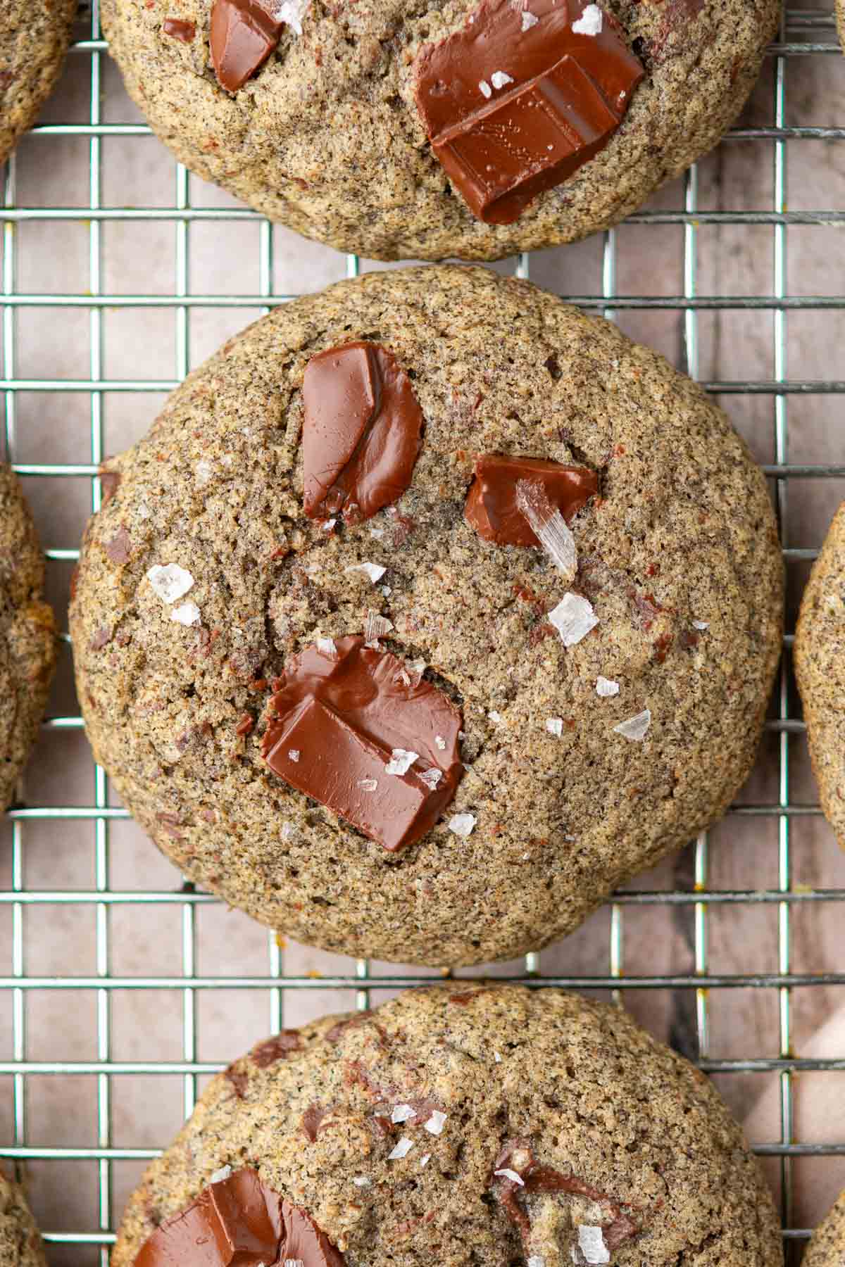 Sourdough buckwheat chocolate chip cookies on a wire rack.