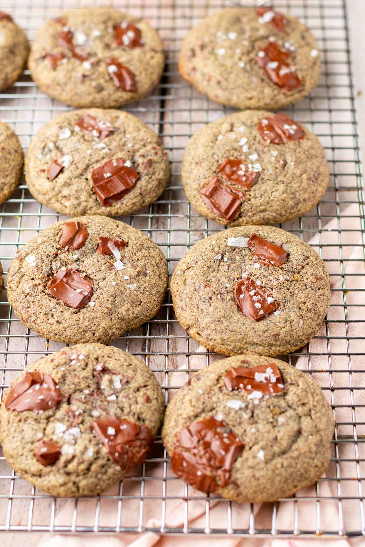 Sourdough buckwheat chocolate chip cookies on a wire rack.