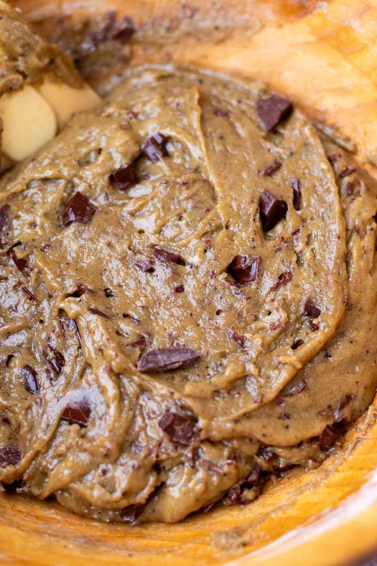 Mixed sourdough rye chocolate chip cookie dough with chocolate chunks in a bowl.