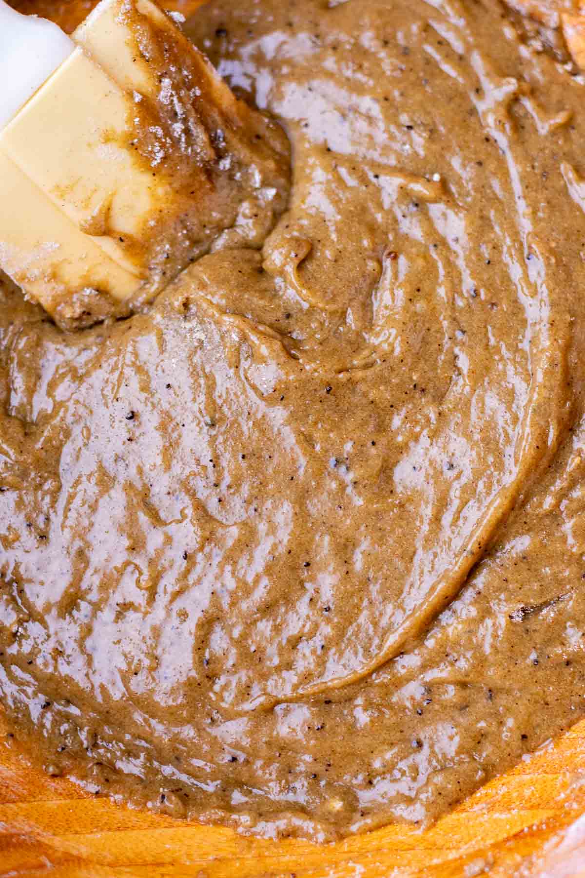 Mixed sourdough rye chocolate chip cookie dough in a bowl with a spatula.