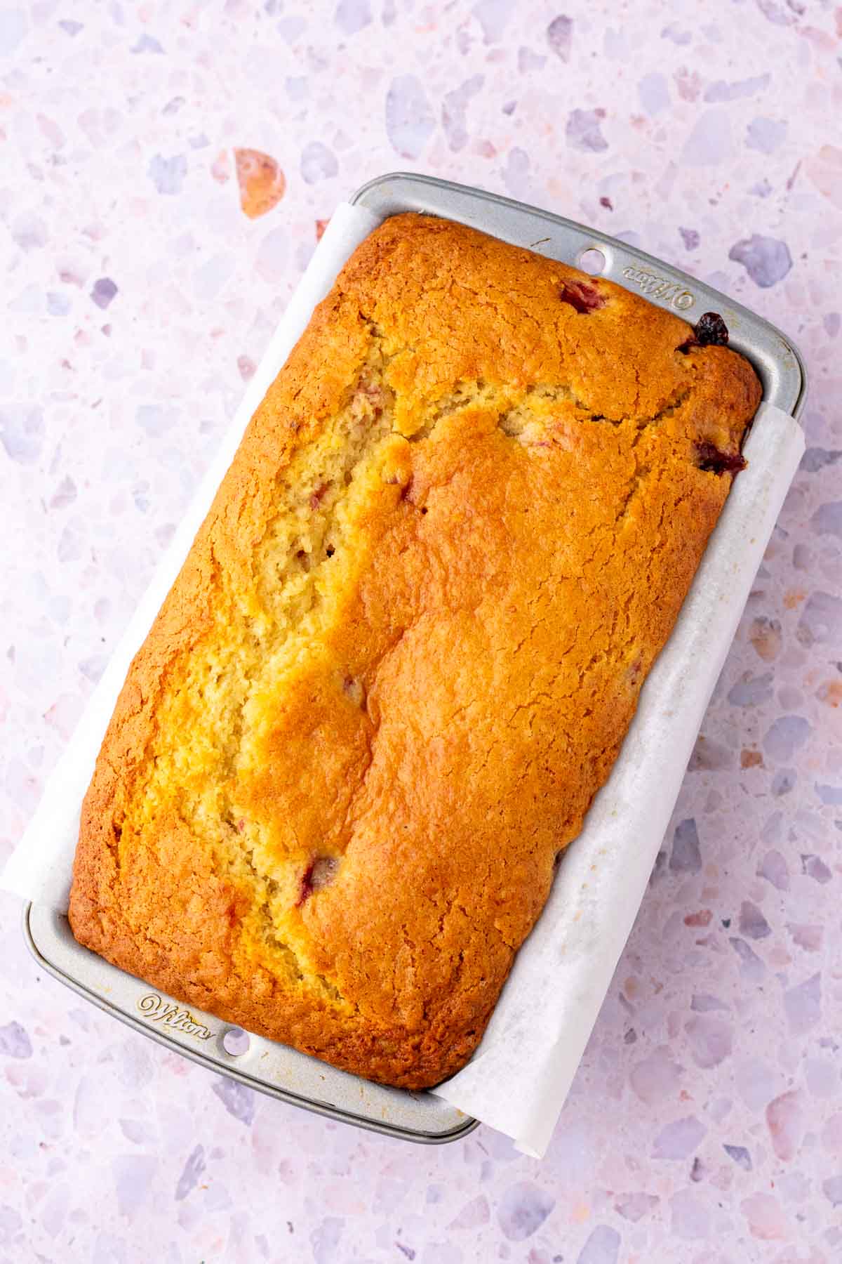 Baked Sourdough Strawberry Bread in a loaf pan.