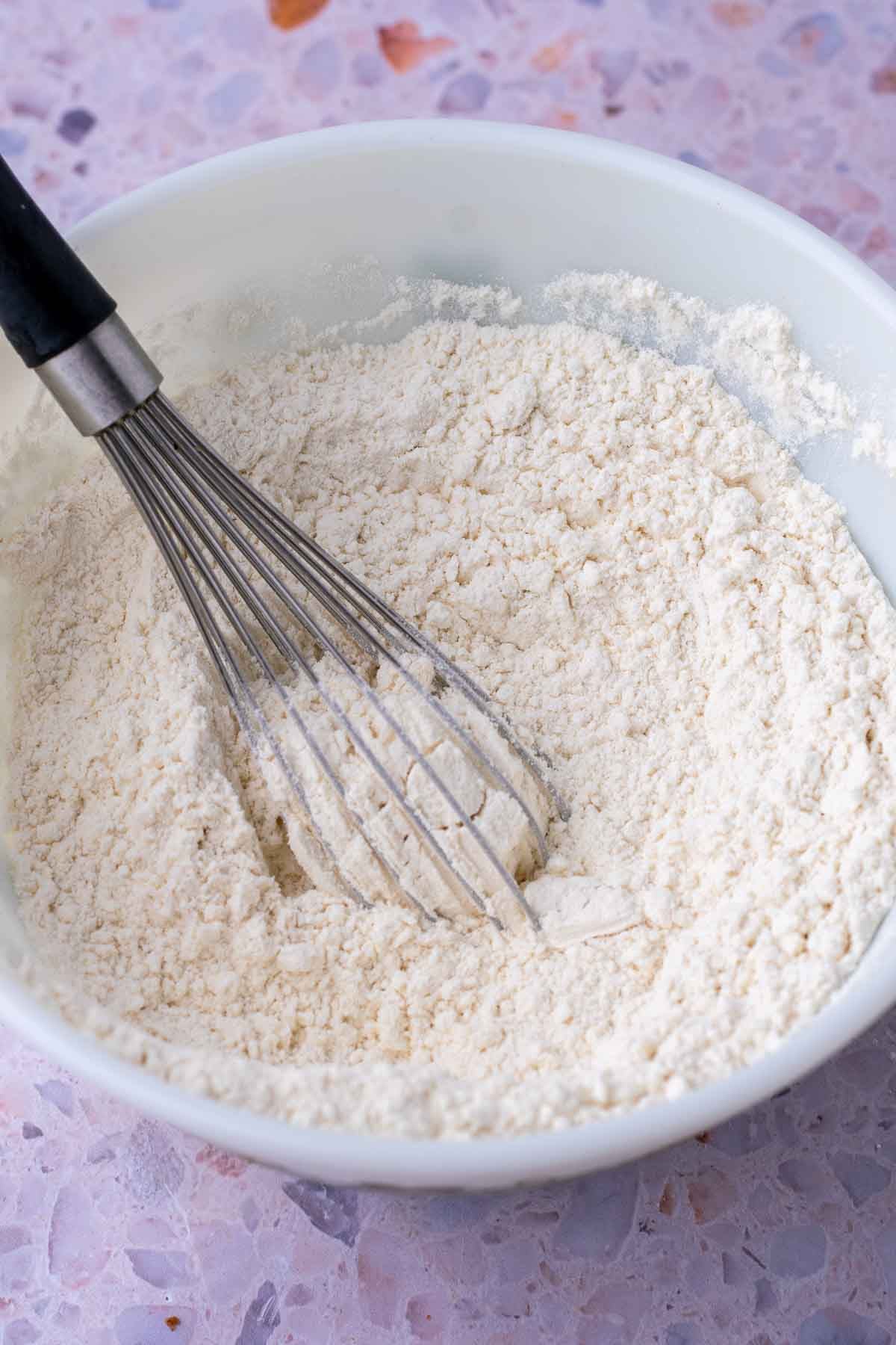 Bowl with whisk of dry ingredients for Sourdough Strawberry Bread.