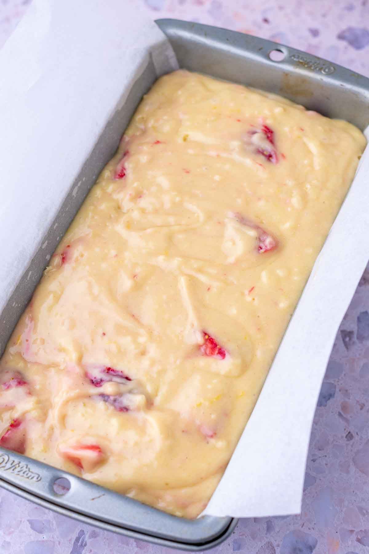 Unbaked Sourdough Strawberry Bread in a loaf pan.