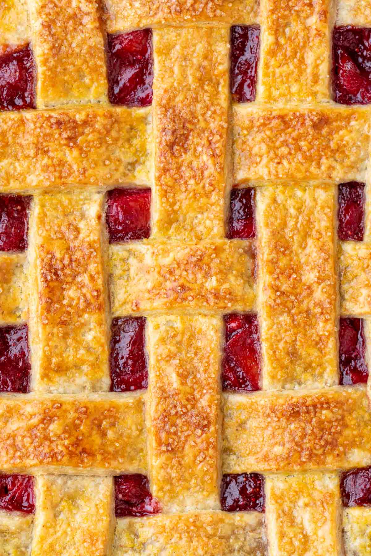 Close up of sourdough graham cracker pie crust lattice on a strawberry rhubarb pie.